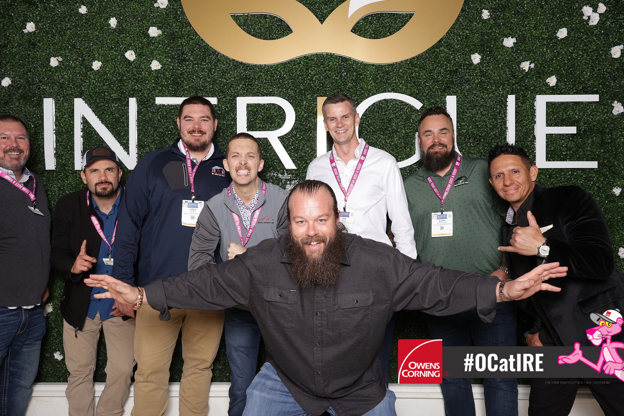 Bearded contractor front and center with the crew behind him hamming it up at Owens Corning at IRE 2024