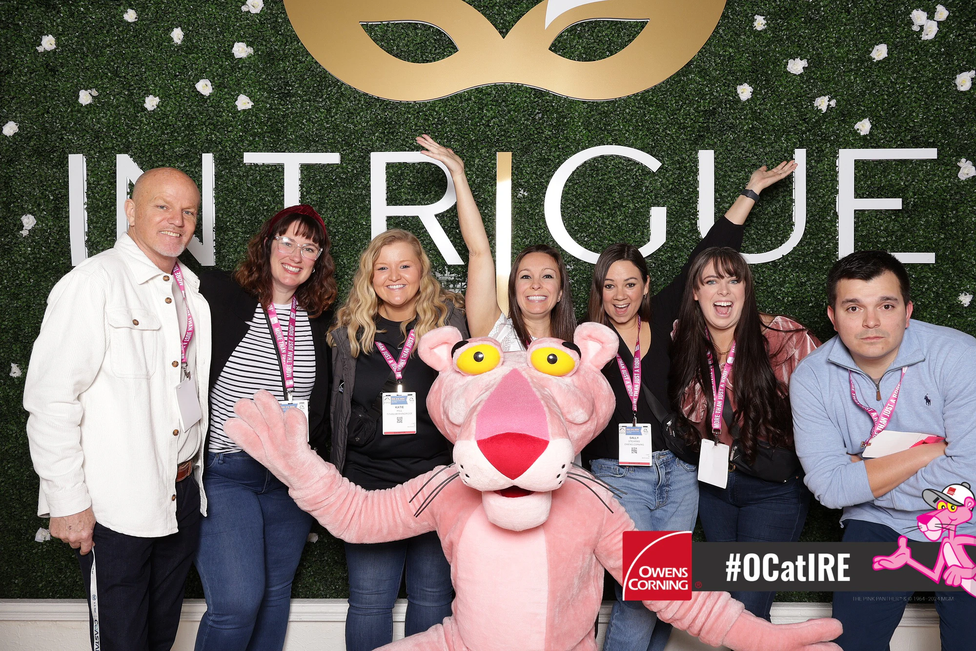 Panther in the middle of a laughing group, one guest with both arms up at Owens Corning at IRE 2024