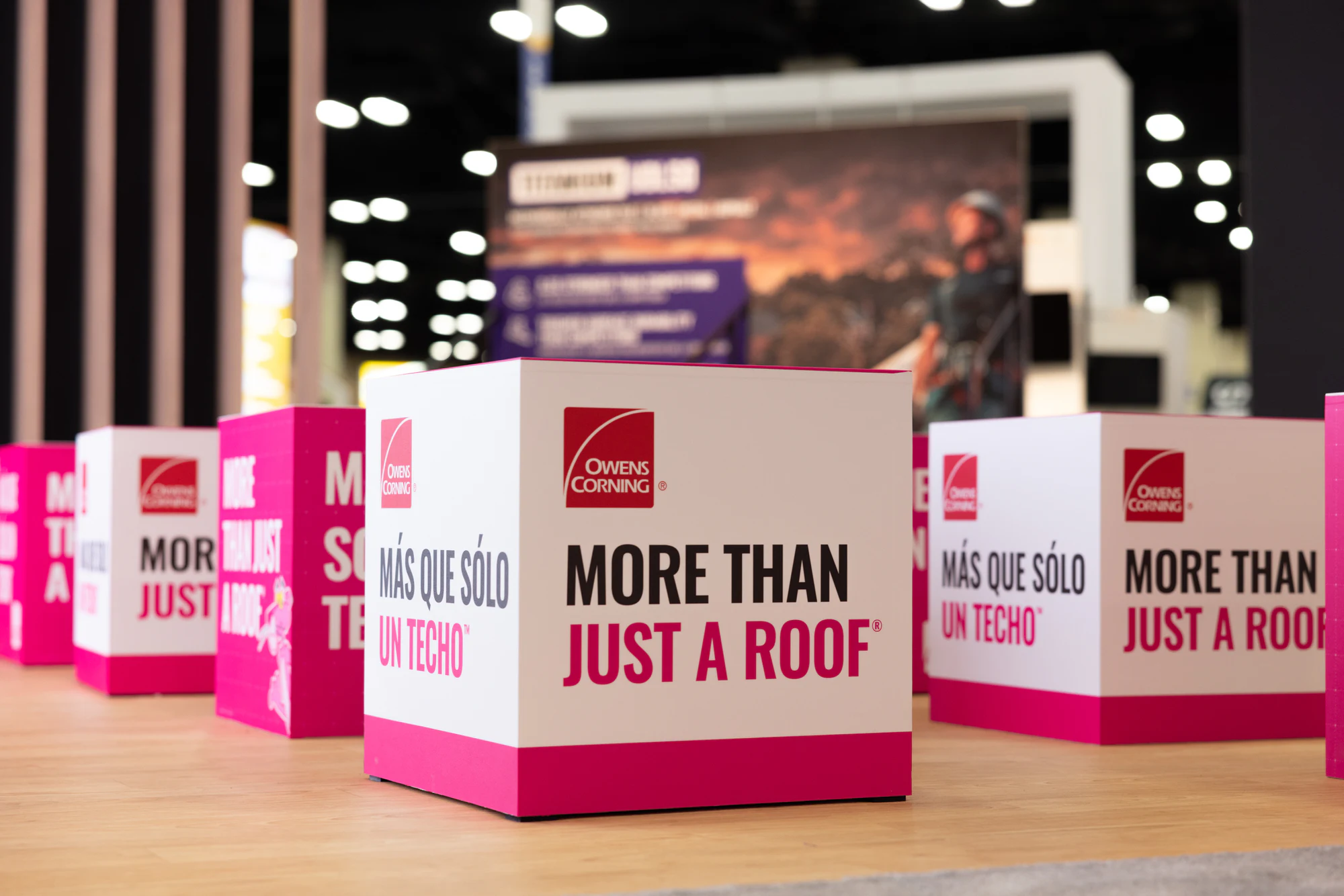 The empty booth on Wednesday: the pink cubes and More Than Just a Roof messaging at Owens Corning at IRE 2025
