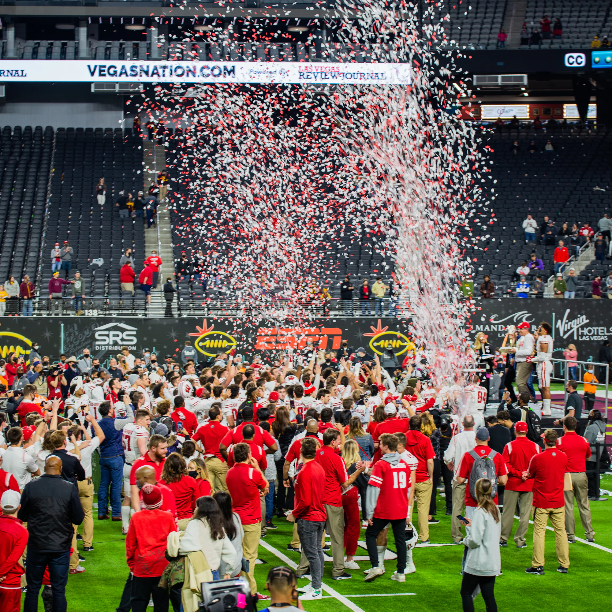 Confetti pouring down on the team celebrating on the field at Owens Corning at the 2021 Las Vegas Bowl