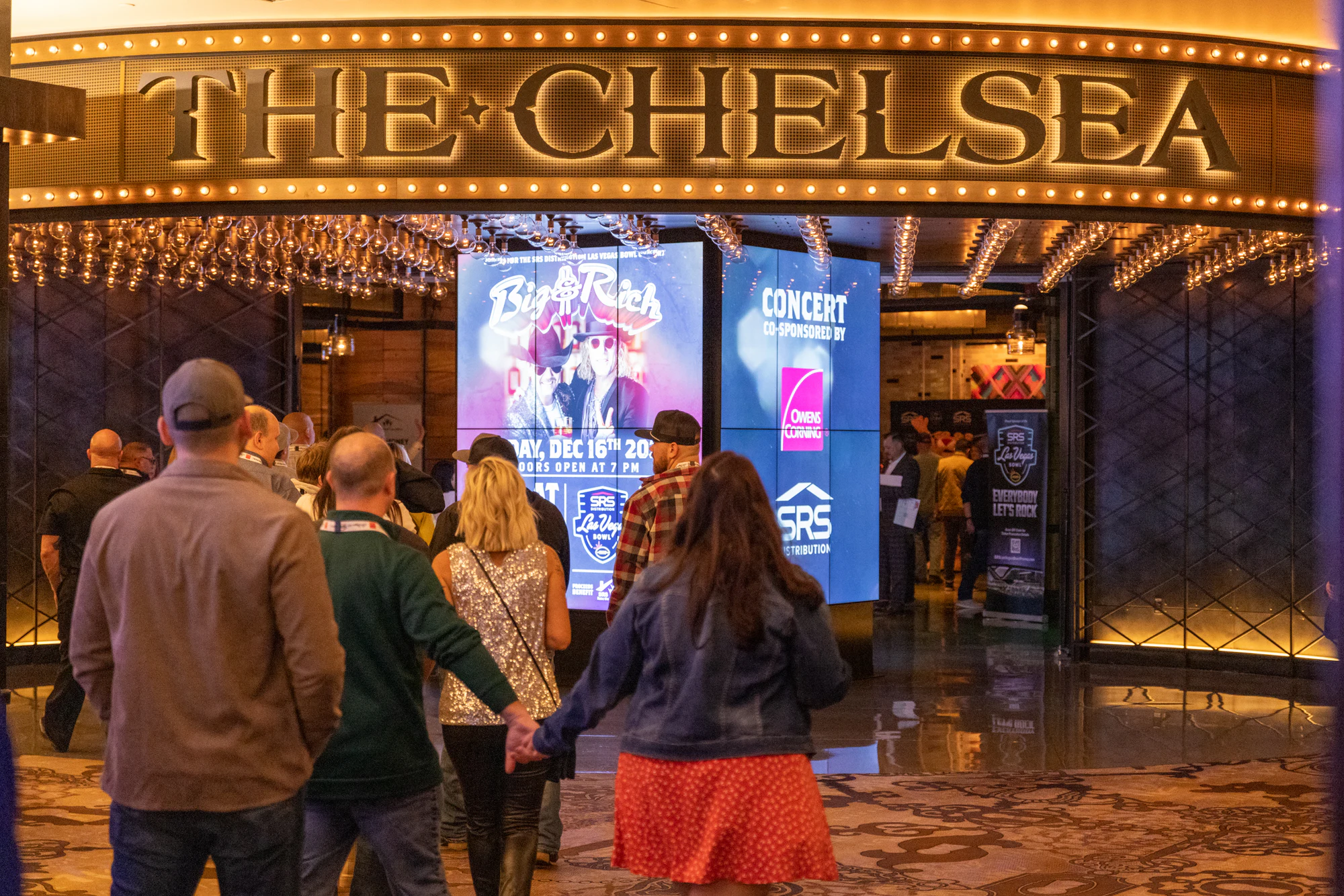 Guests walking into The Chelsea under the marquee at Owens Corning at the 2022 Las Vegas Bowl