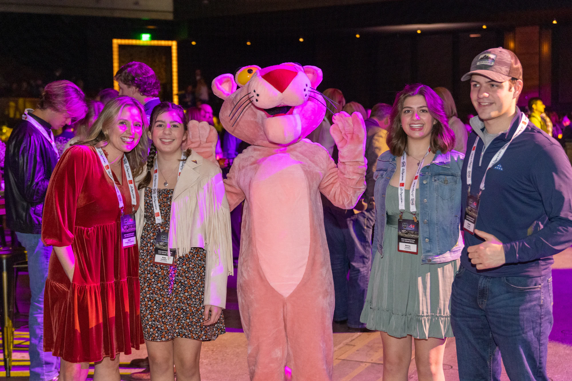Pink Panther mascot waving with four guests on the dance floor at Owens Corning at the 2022 Las Vegas Bowl