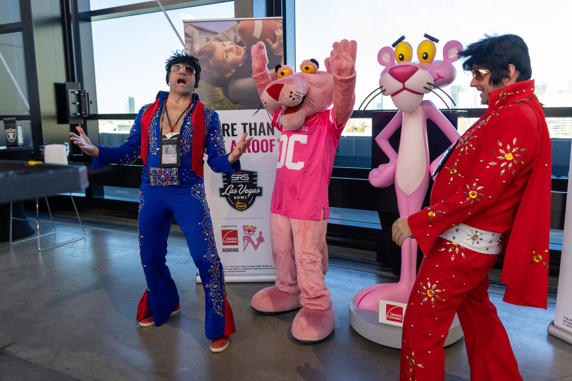 Both Elvis performers and the Pink Panther mascot full length at Owens Corning at the 2022 Las Vegas Bowl