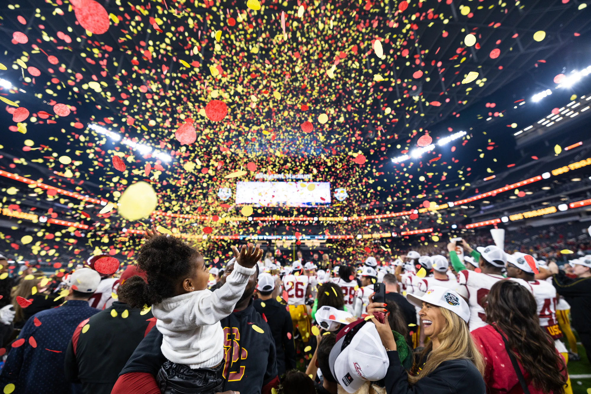Red and gold confetti fills the stadium air over the winning team's celebration at Owens Corning at the 2024 Las Vegas Bowl