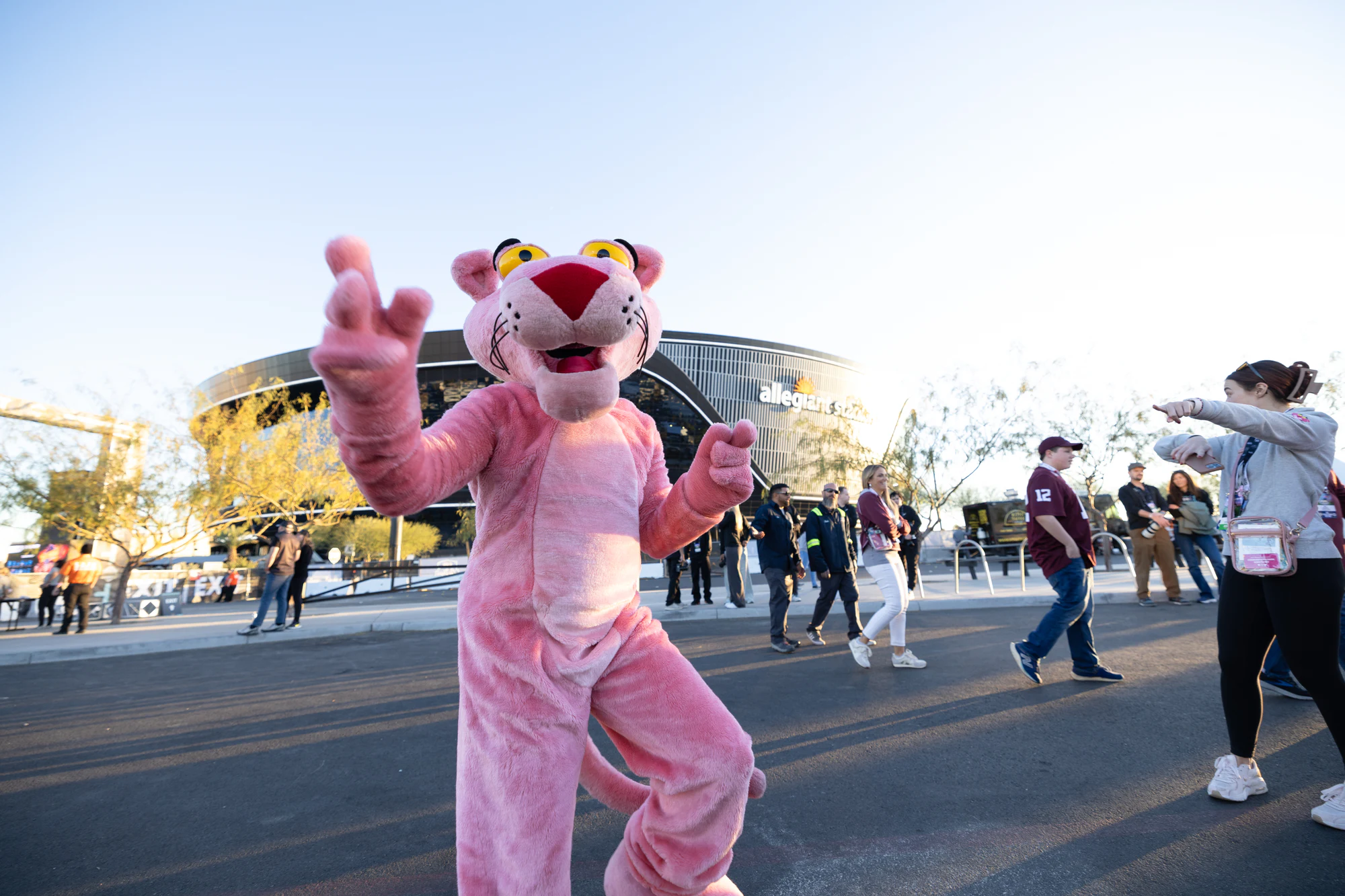 The Pink Panther waves at Fan Fest with Allegiant Stadium in the background at Owens Corning at the 2024 Las Vegas Bowl