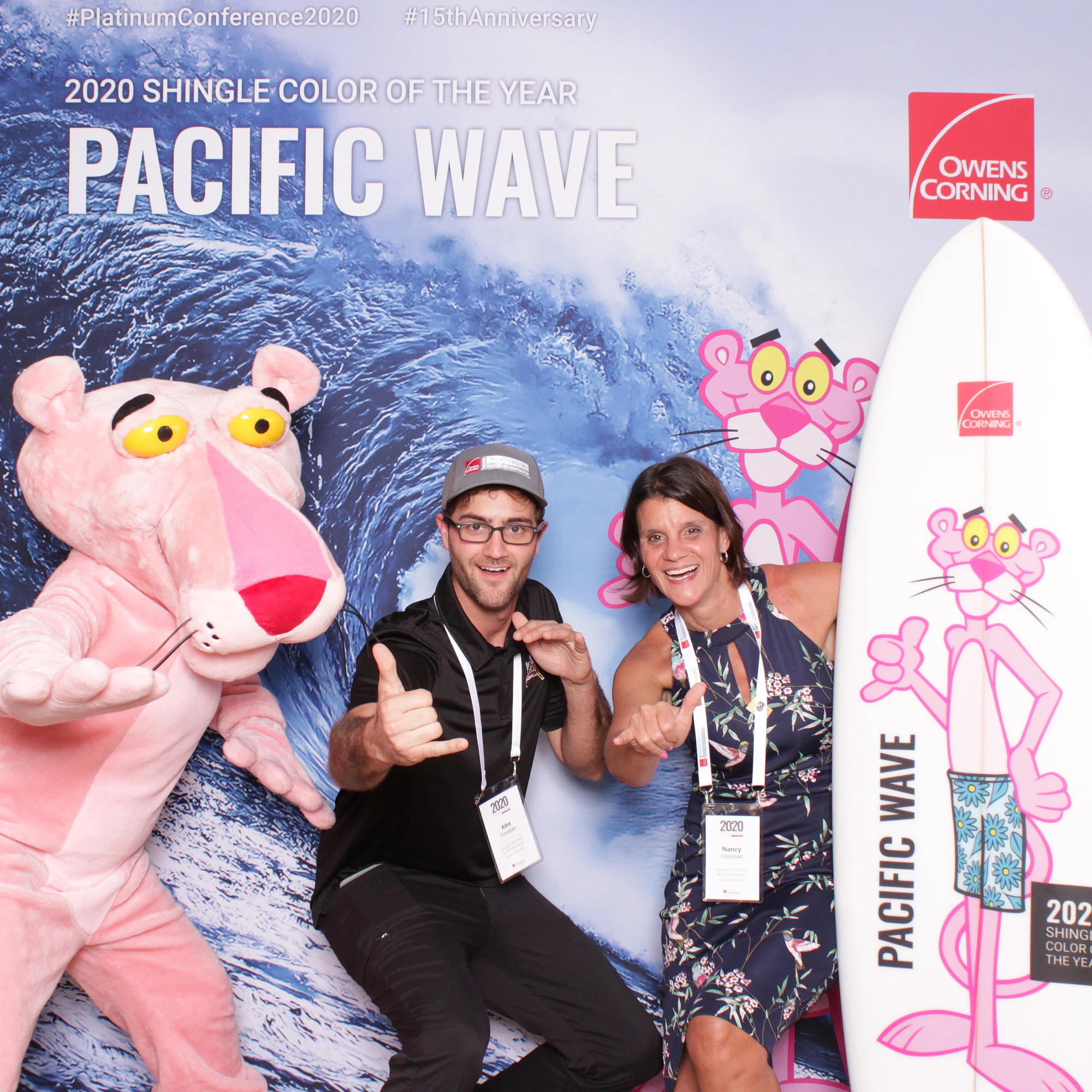 Three with thumbs up, smiling at Owens Corning Platinum Conference