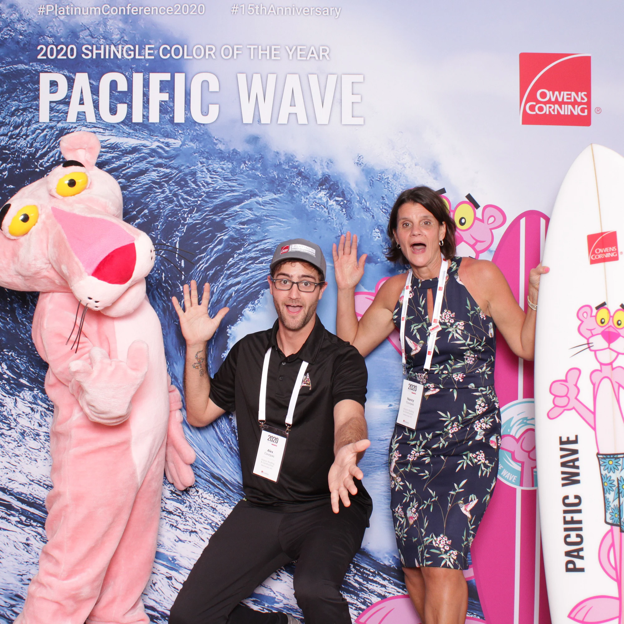 The two with hands up and mouths open in mock surprise at Owens Corning Platinum Conference