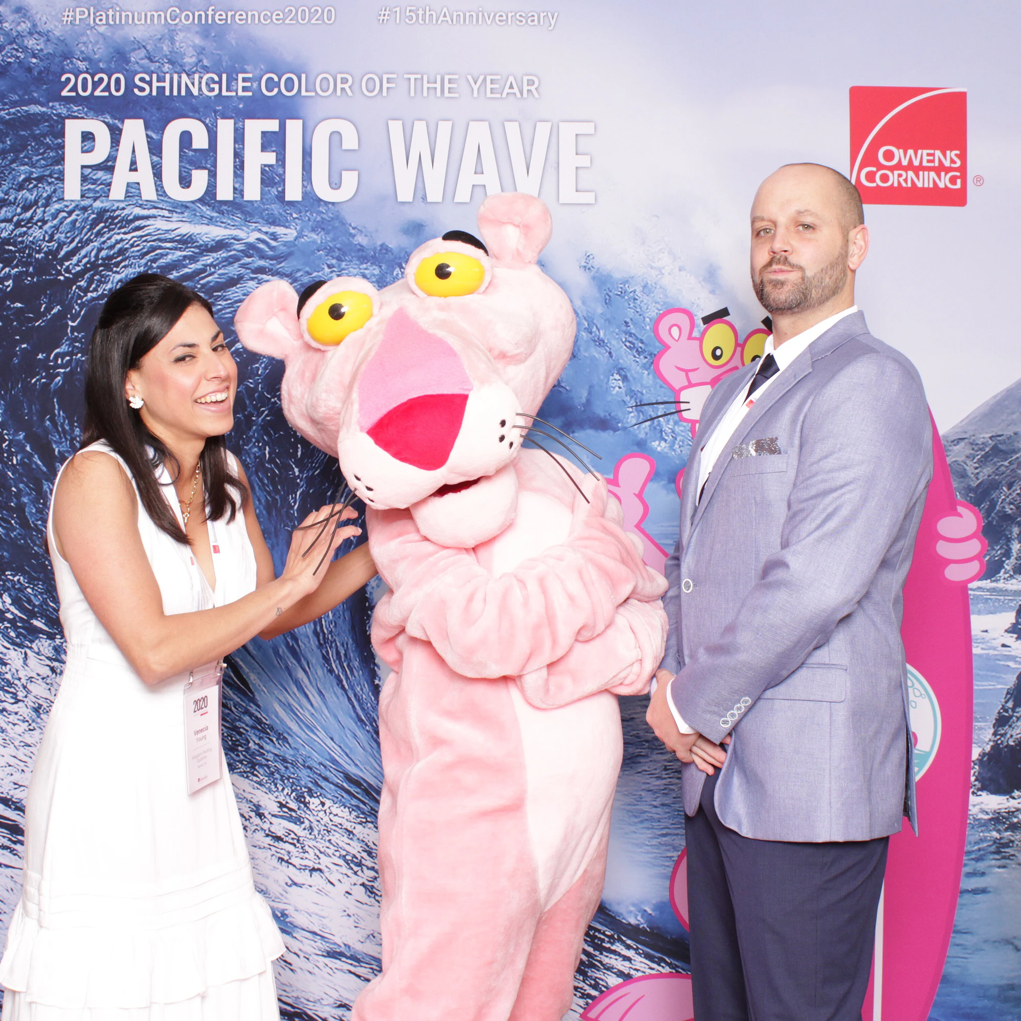 She reaches over to the Panther while he stands tall at Owens Corning Platinum Conference