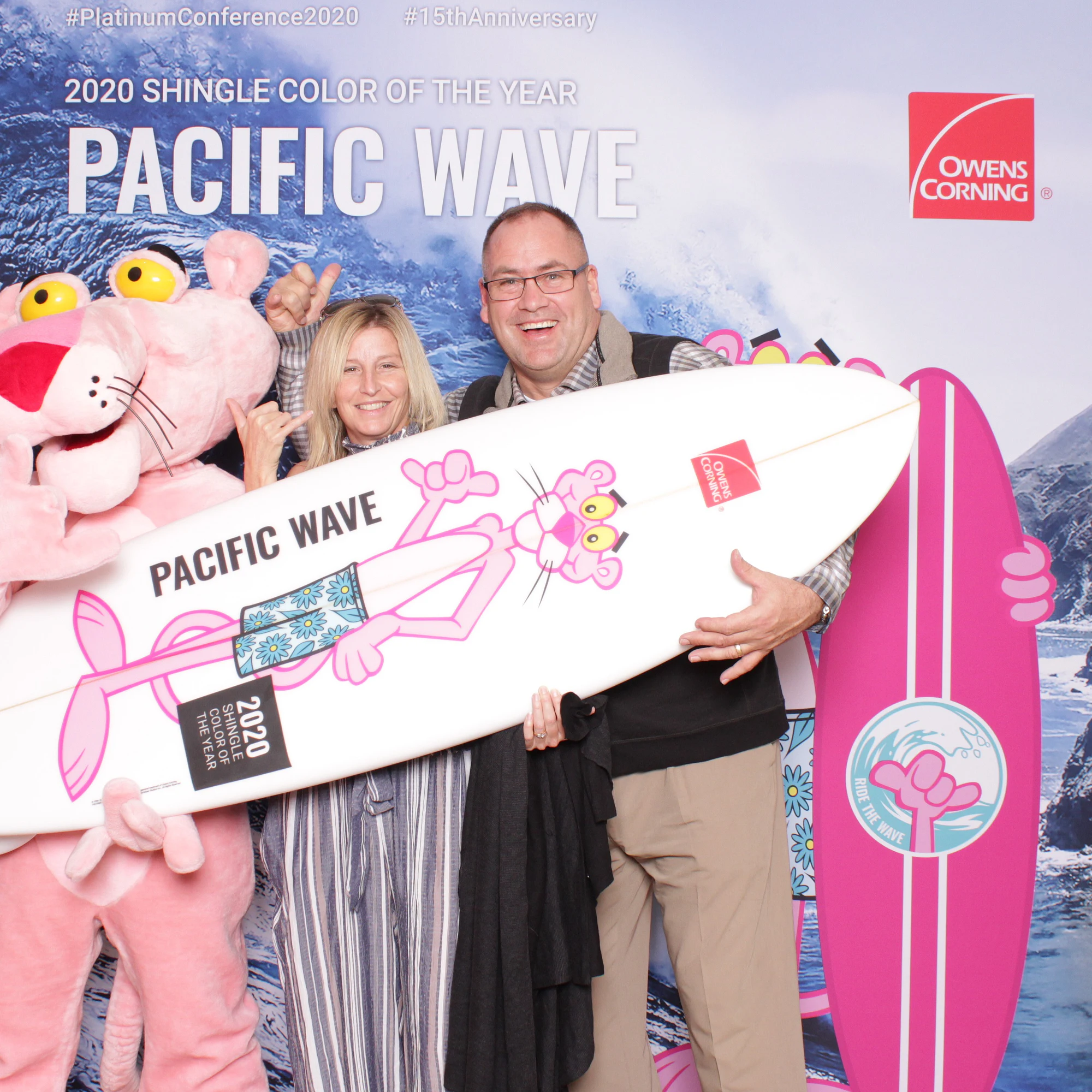 The two again, the Panther waving behind the board at Owens Corning Platinum Conference