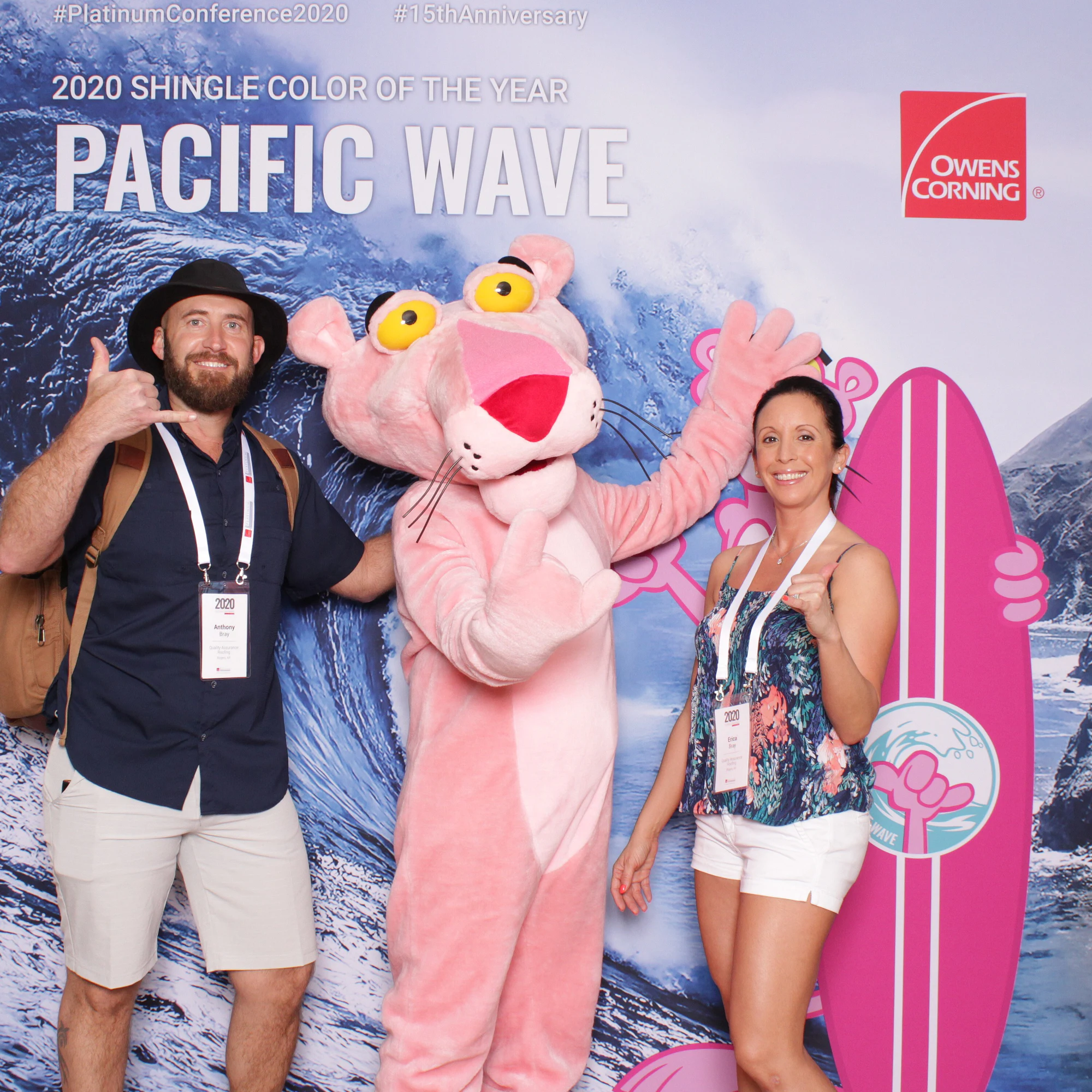 The two throwing hang-loose signs with the Panther at Owens Corning Platinum Conference