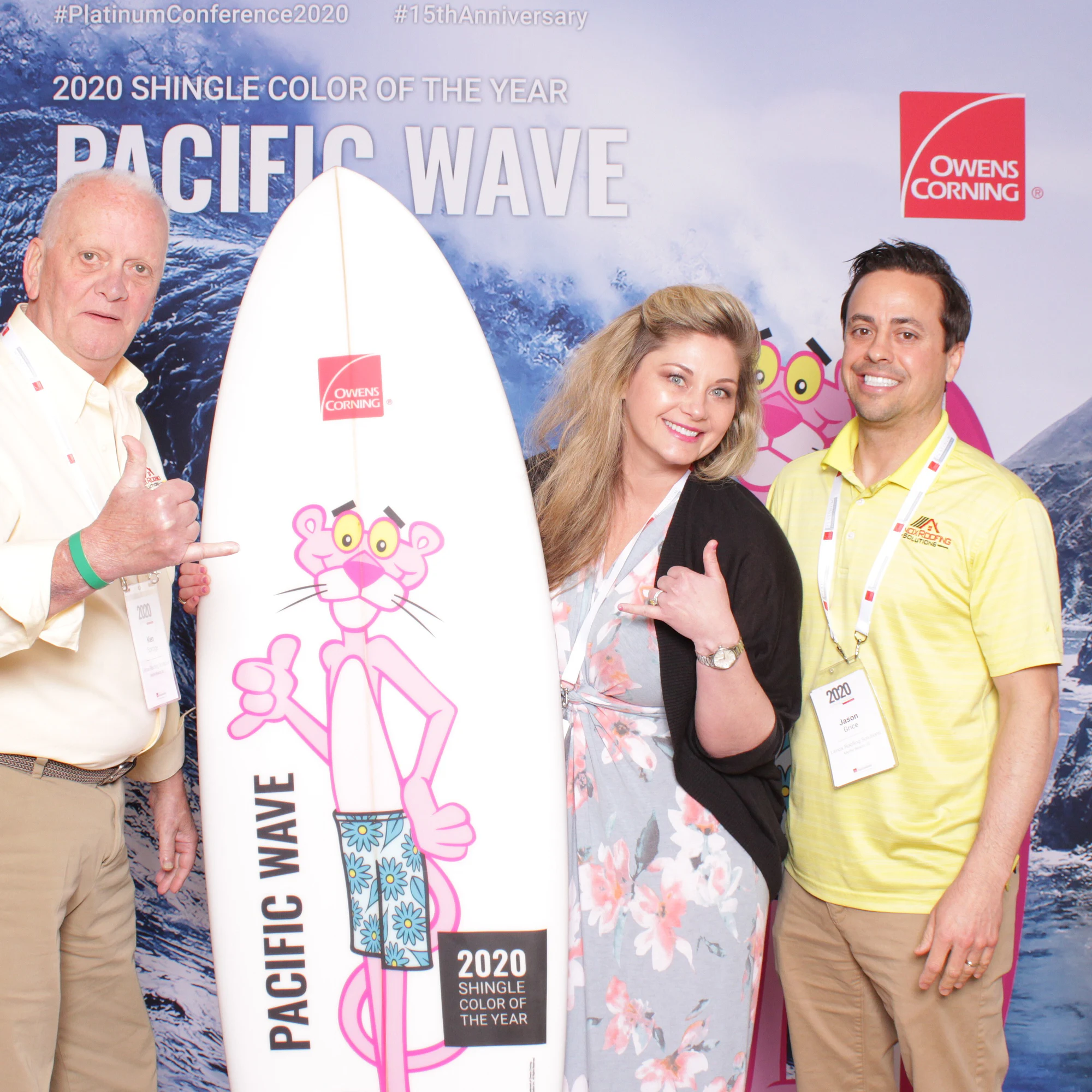 The three again, two of them throwing hang-loose signs beside the board at Owens Corning Platinum Conference