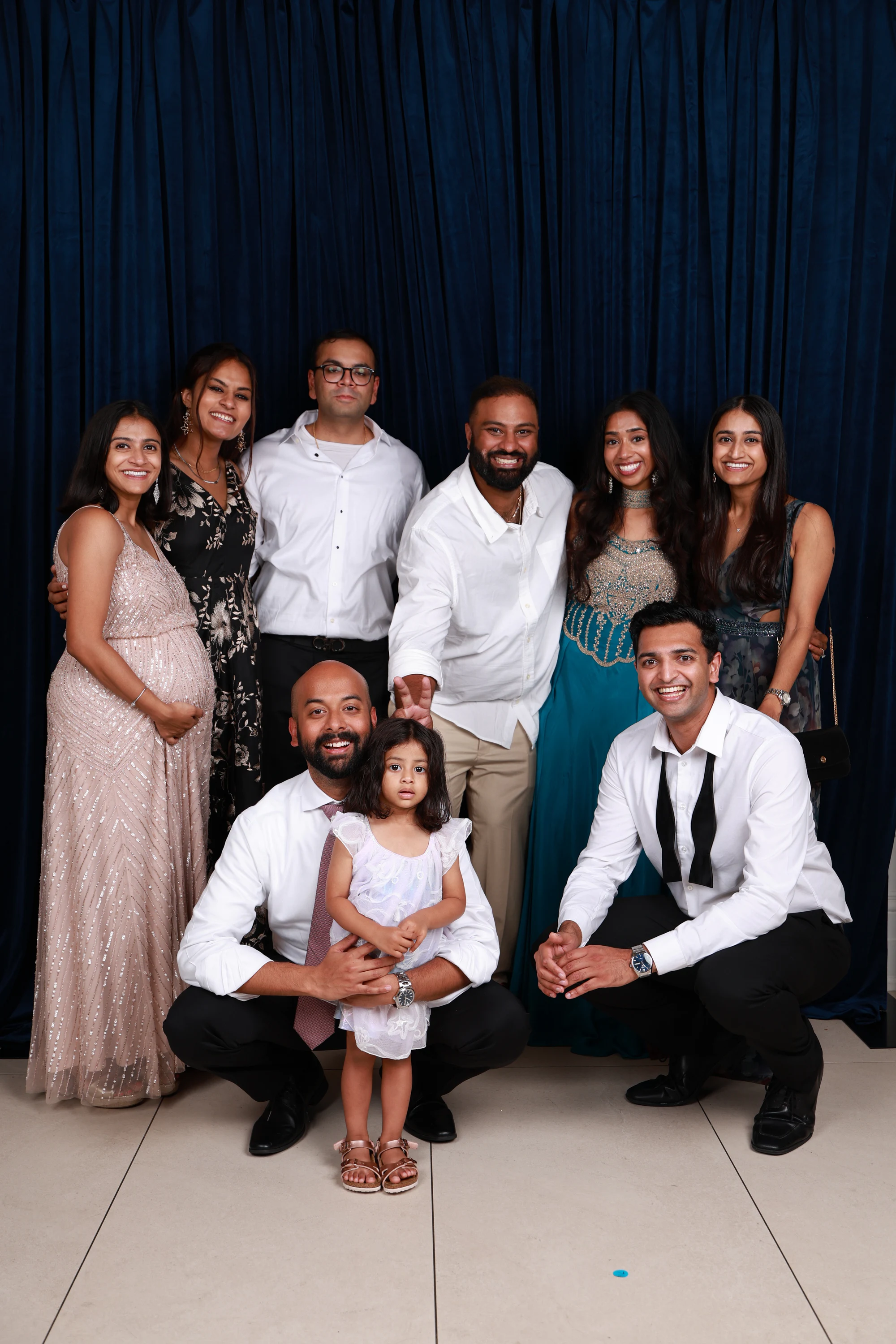 Family group with the adults crouched around the kids at Ramya + Sreehari