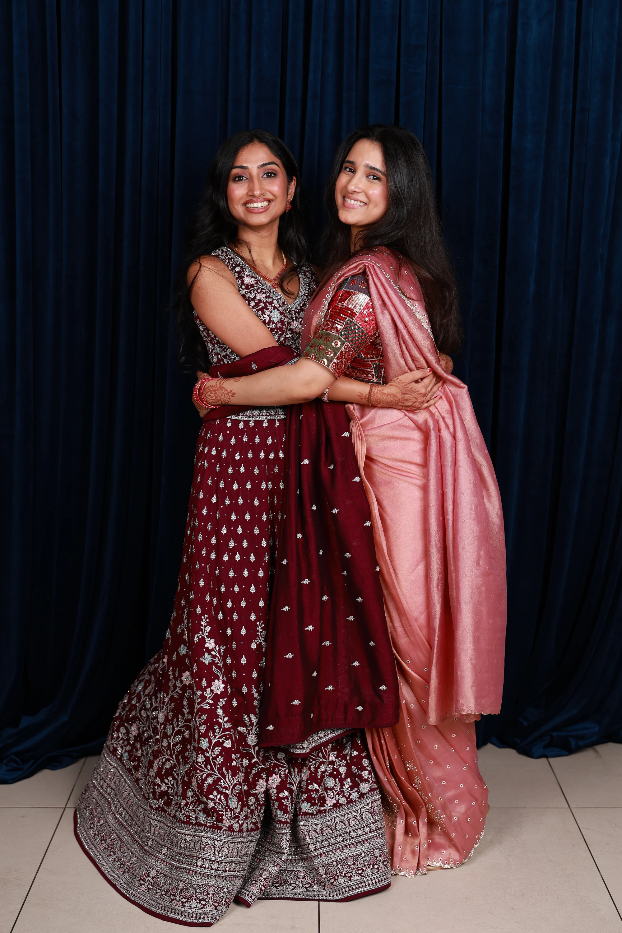 The same pair standing, arms linked, full length at Ramya + Sreehari