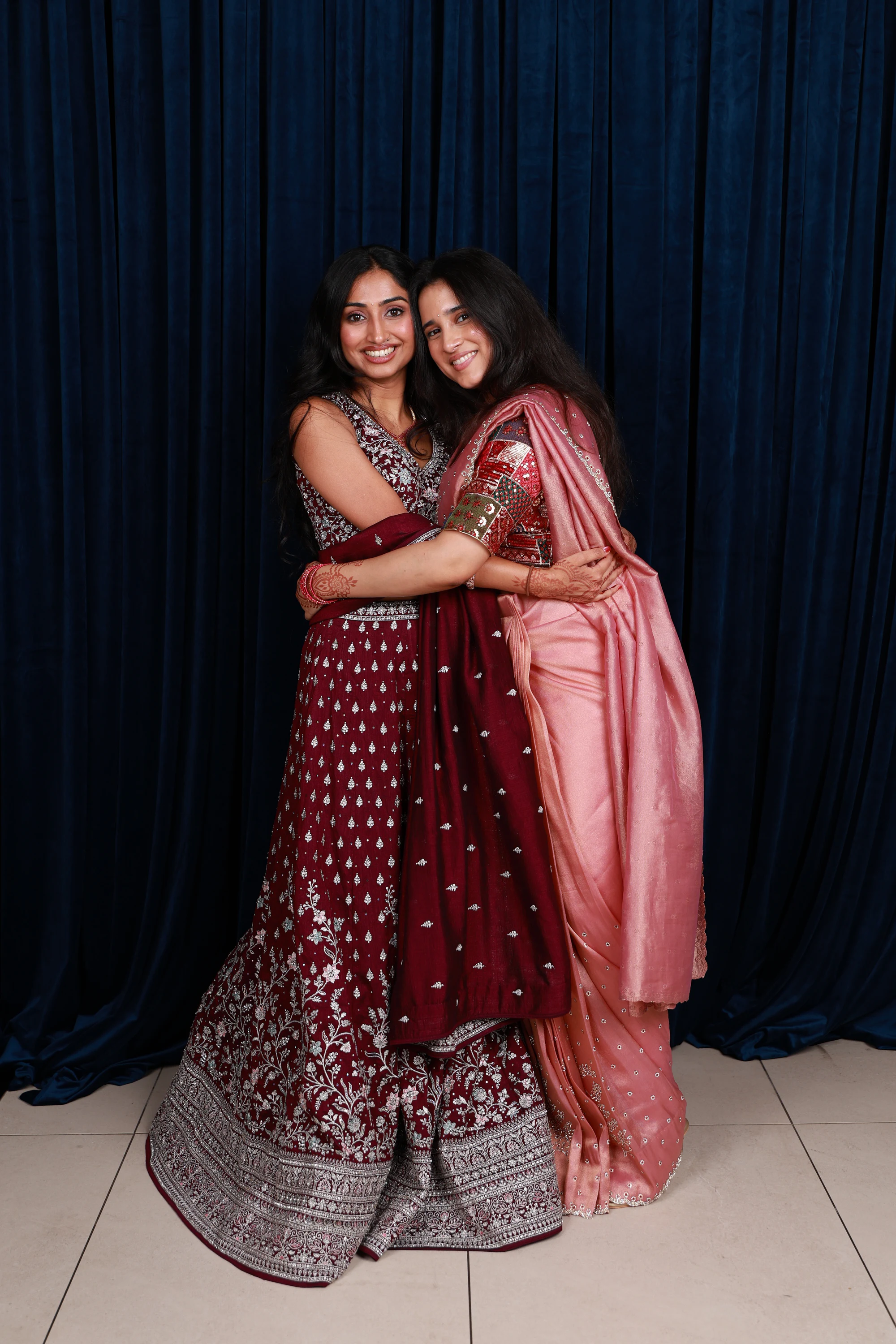 The same pair full length, hugging and smiling at the camera at Ramya + Sreehari