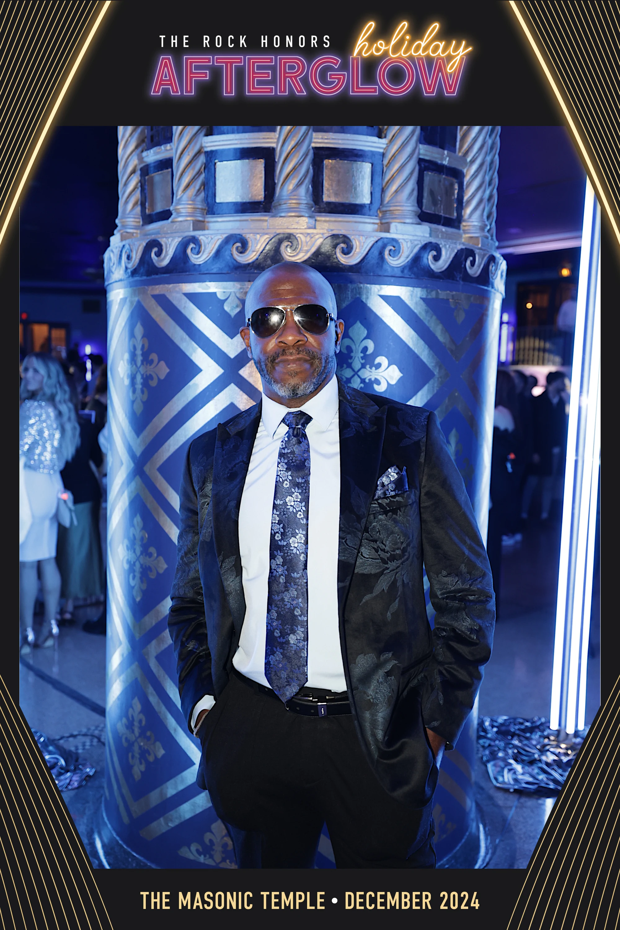 Sunglasses and a suit in the blue arch at Rock Honors AfterGlow