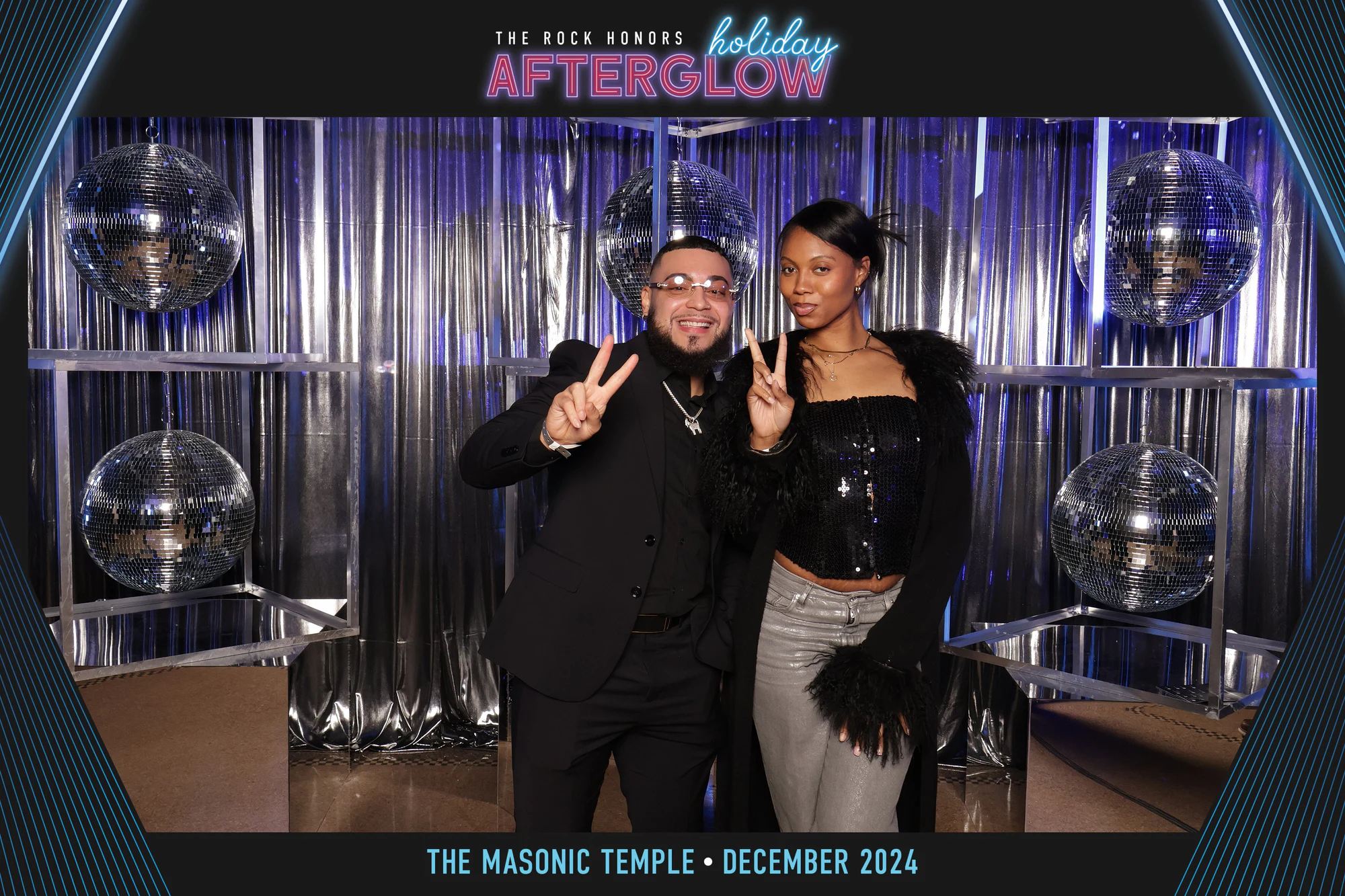 Two throwing peace signs against the silver fringe at Rock Honors AfterGlow