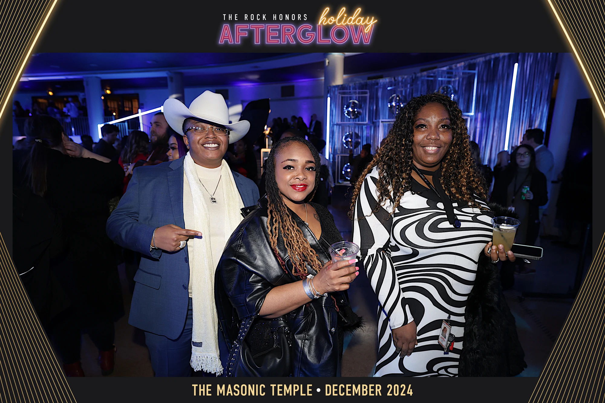 Three guests in the blue room, one in a white cowboy hat, in the AfterGlow frame at Rock Honors AfterGlow