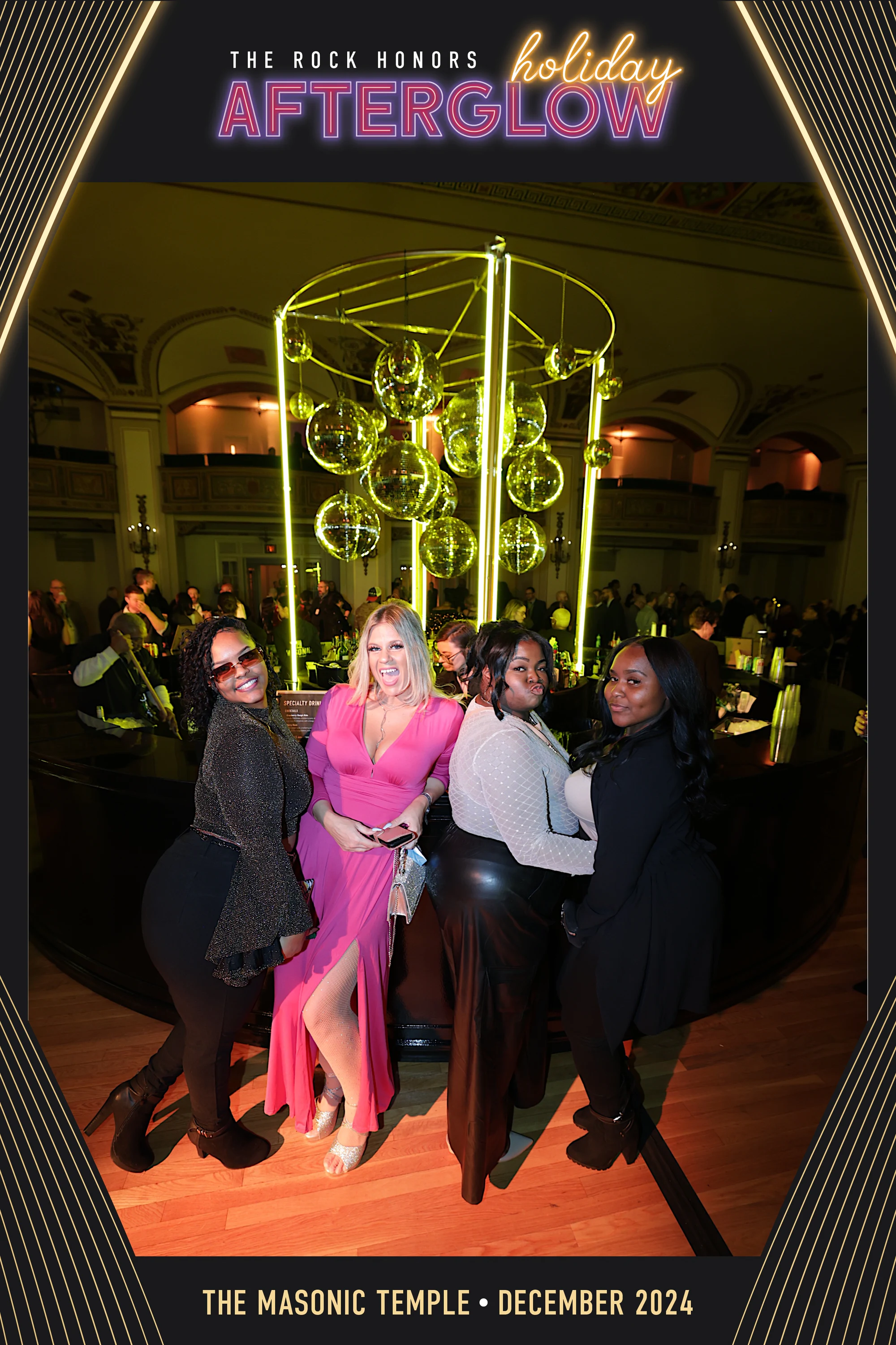 Four guests by the neon chandelier in the ballroom, in the AfterGlow frame at Rock Honors AfterGlow