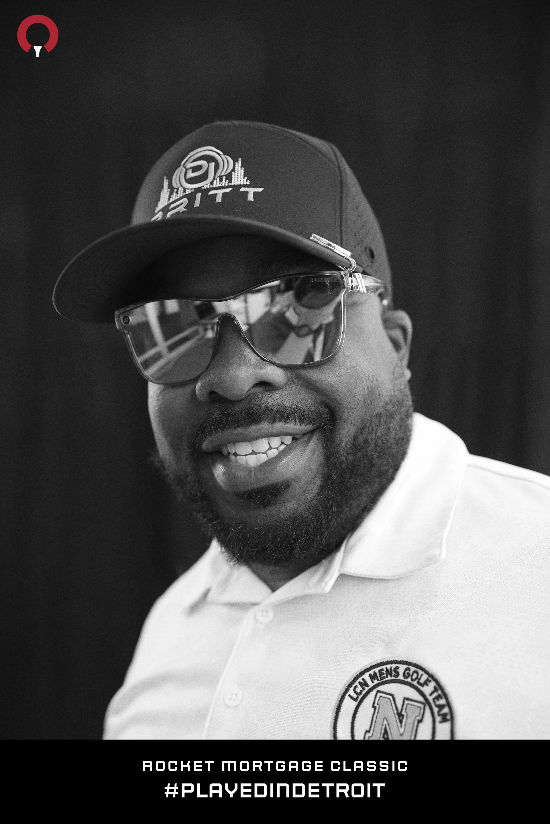 Sunglasses pushed up on the cap, head back, laughing at Rocket Mortgage Classic 2024
