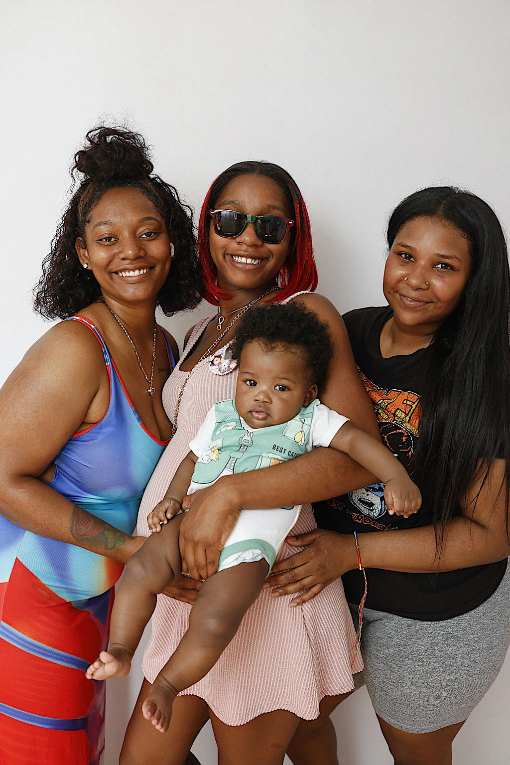 Three women and a baby at My Chosen Family Portraits at Motor City Pride 2025