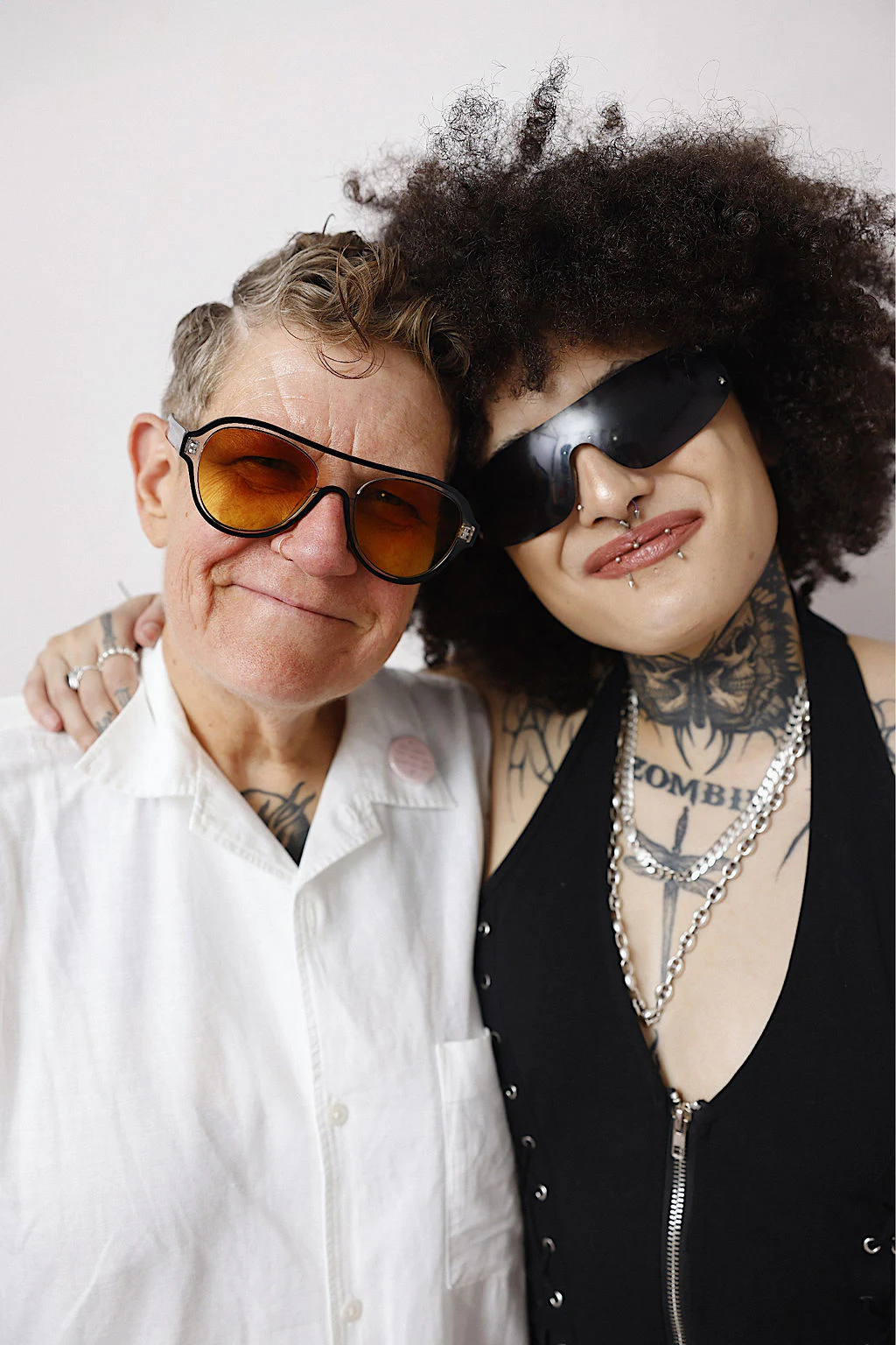 Older and younger friend in sunglasses at My Chosen Family Portraits at Motor City Pride 2025