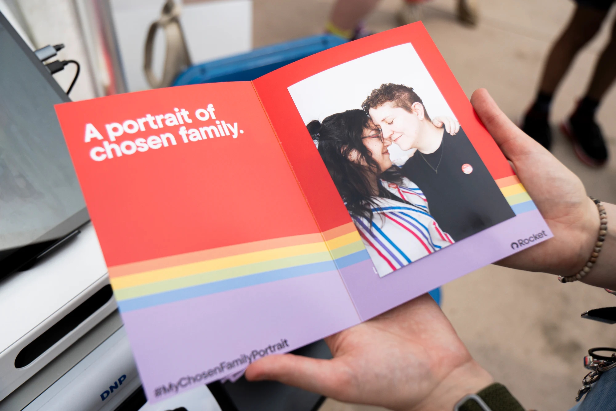 Printed card: “A portrait of chosen family” at My Chosen Family Portraits at Motor City Pride 2025
