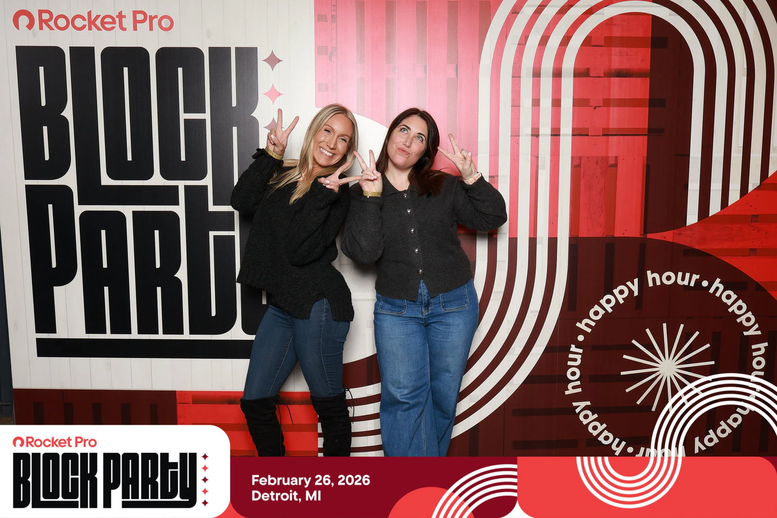Two women in black tops and jeans throwing peace signs at Rocket Pro Block Party