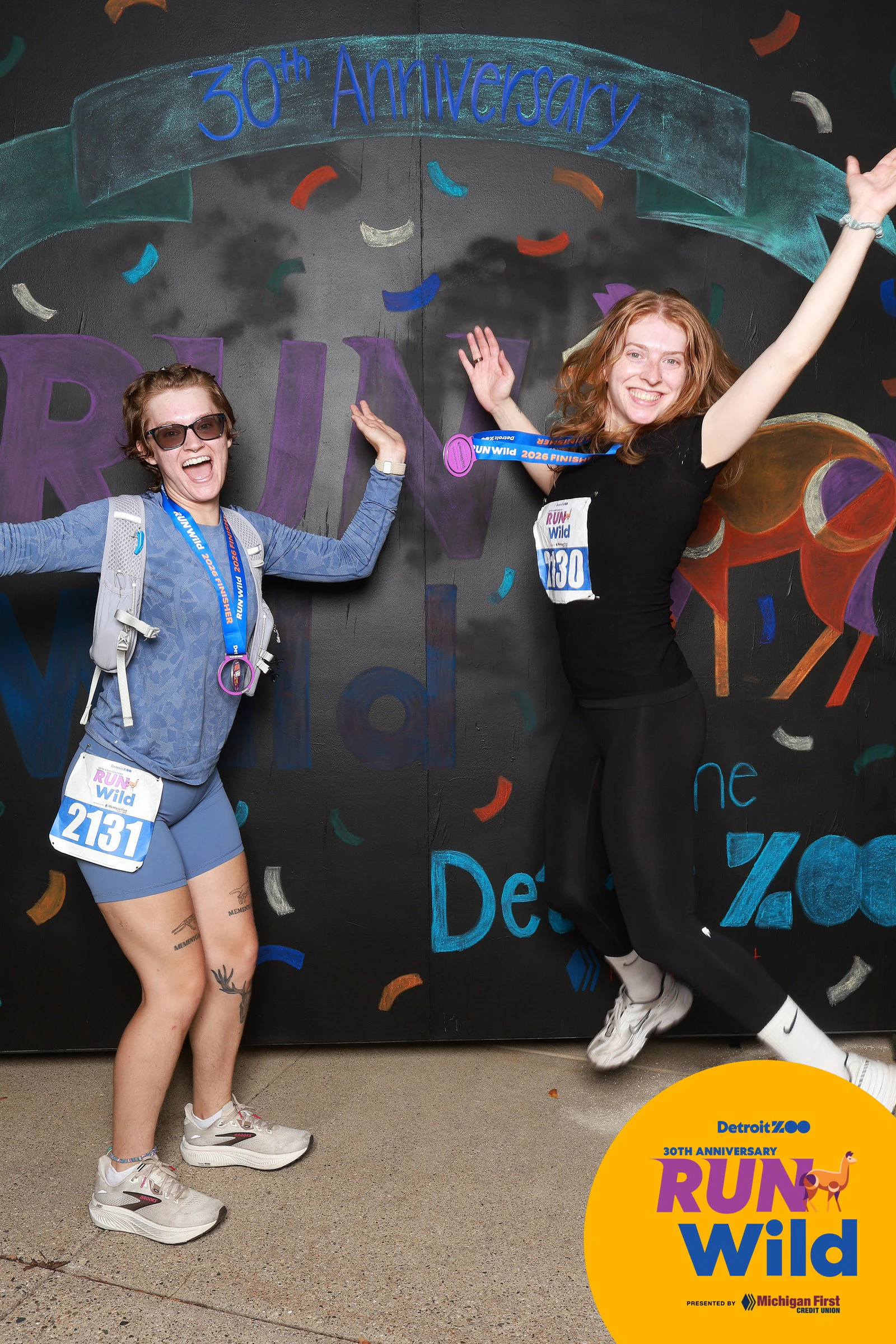 Two friends jumping and dancing at Run Wild at the Detroit Zoo