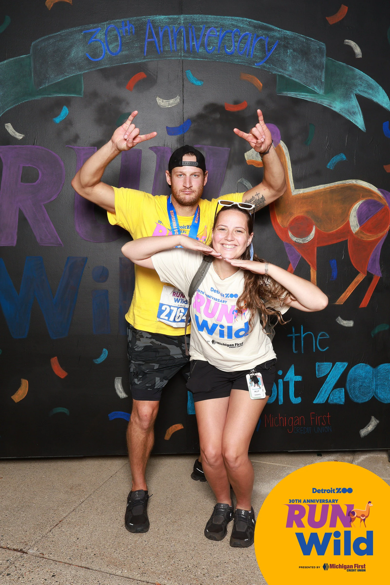 Two runners striking a pose at Run Wild at the Detroit Zoo