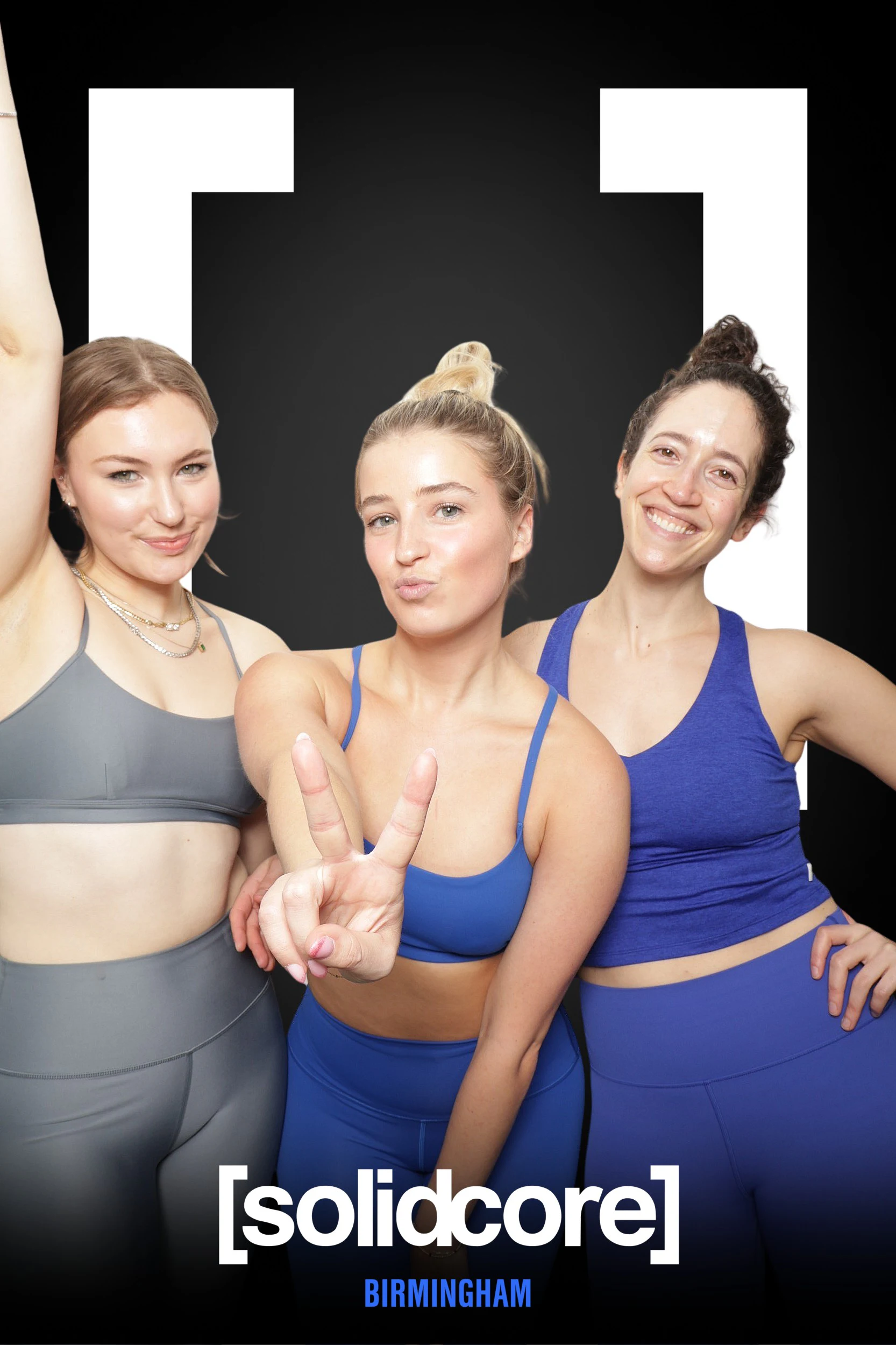 Three guests with peace signs on the background built for Solidcore Birmingham’s grand opening