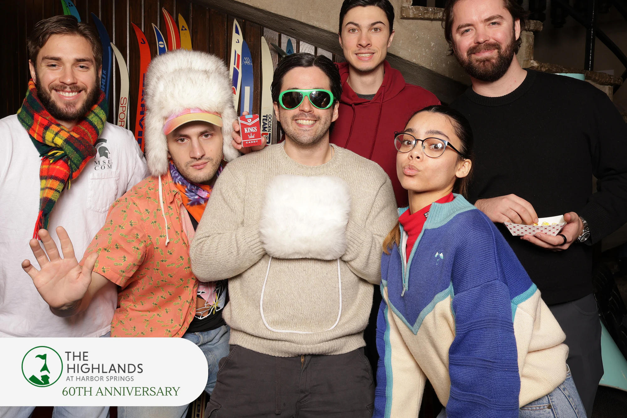 The six friends, one in green sunglasses holding a white fur muff at The Highlands 60th Anniversary