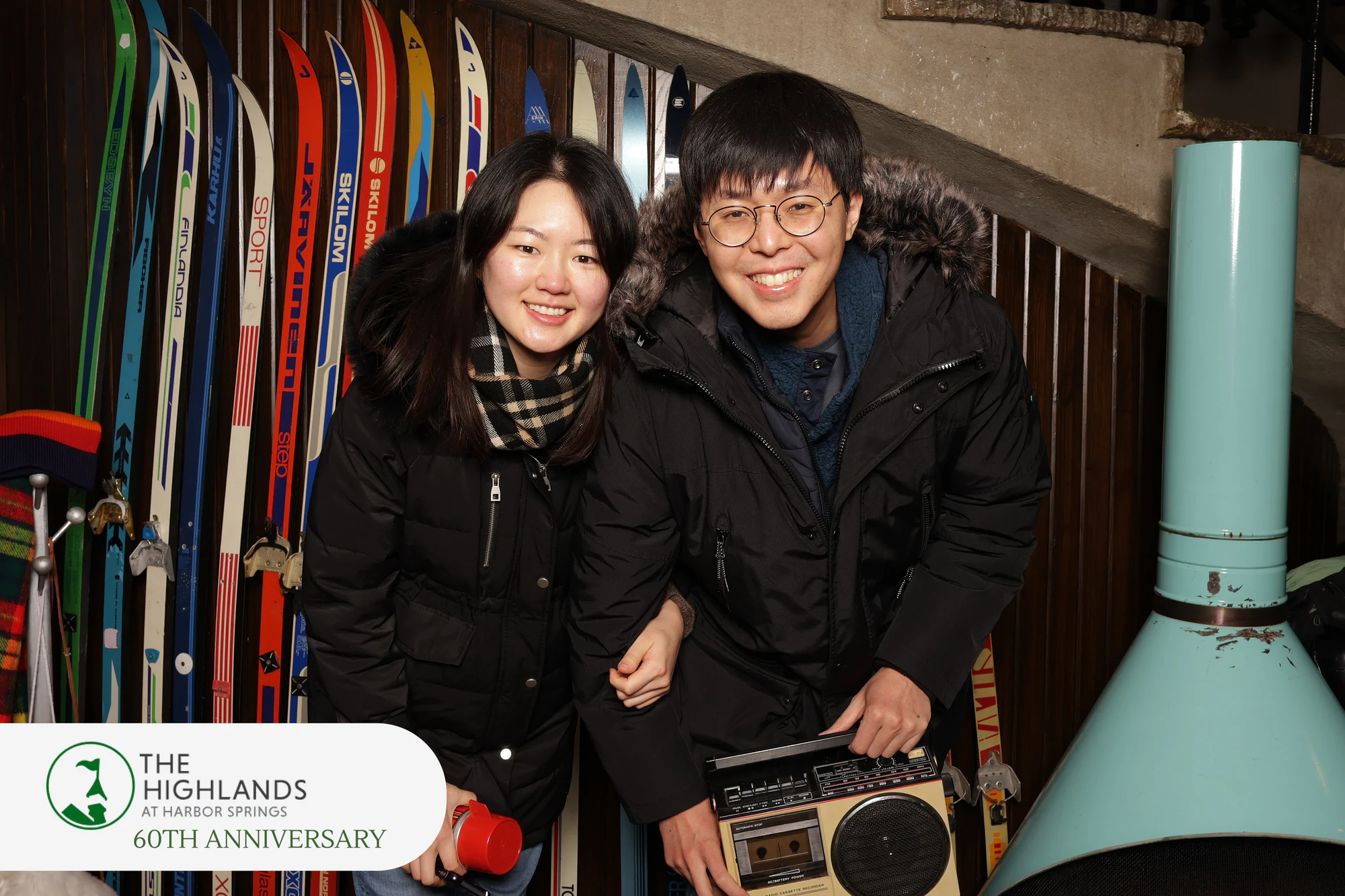 The couple crouched close and grinning, the boombox in front at The Highlands 60th Anniversary
