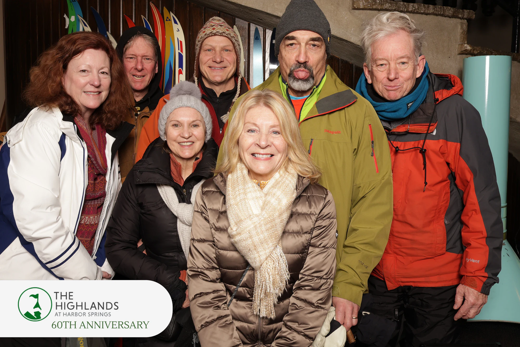 The seven friends, the woman in front in a cream scarf beaming at The Highlands 60th Anniversary