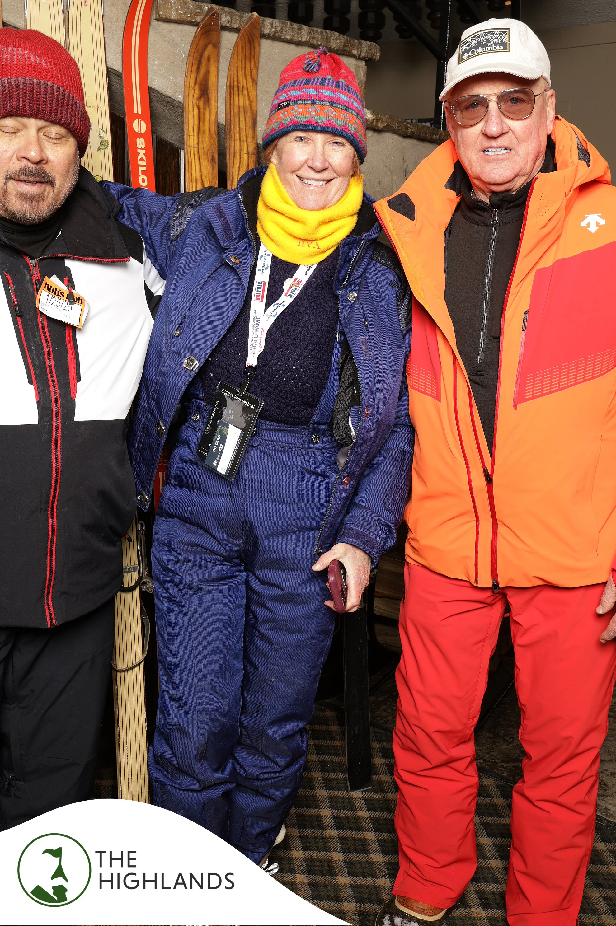 Three friends in ski gear, the woman in the middle in a yellow neck warmer at The Highlands 61st Anniversary
