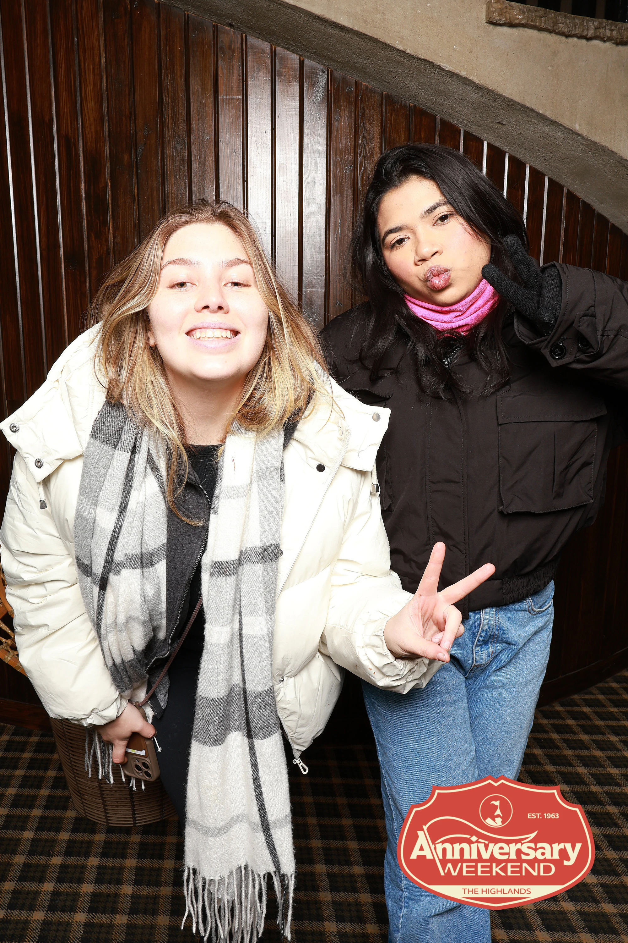 The two friends, one throwing a peace sign, the other pulling a face at The Highlands Anniversary Weekend