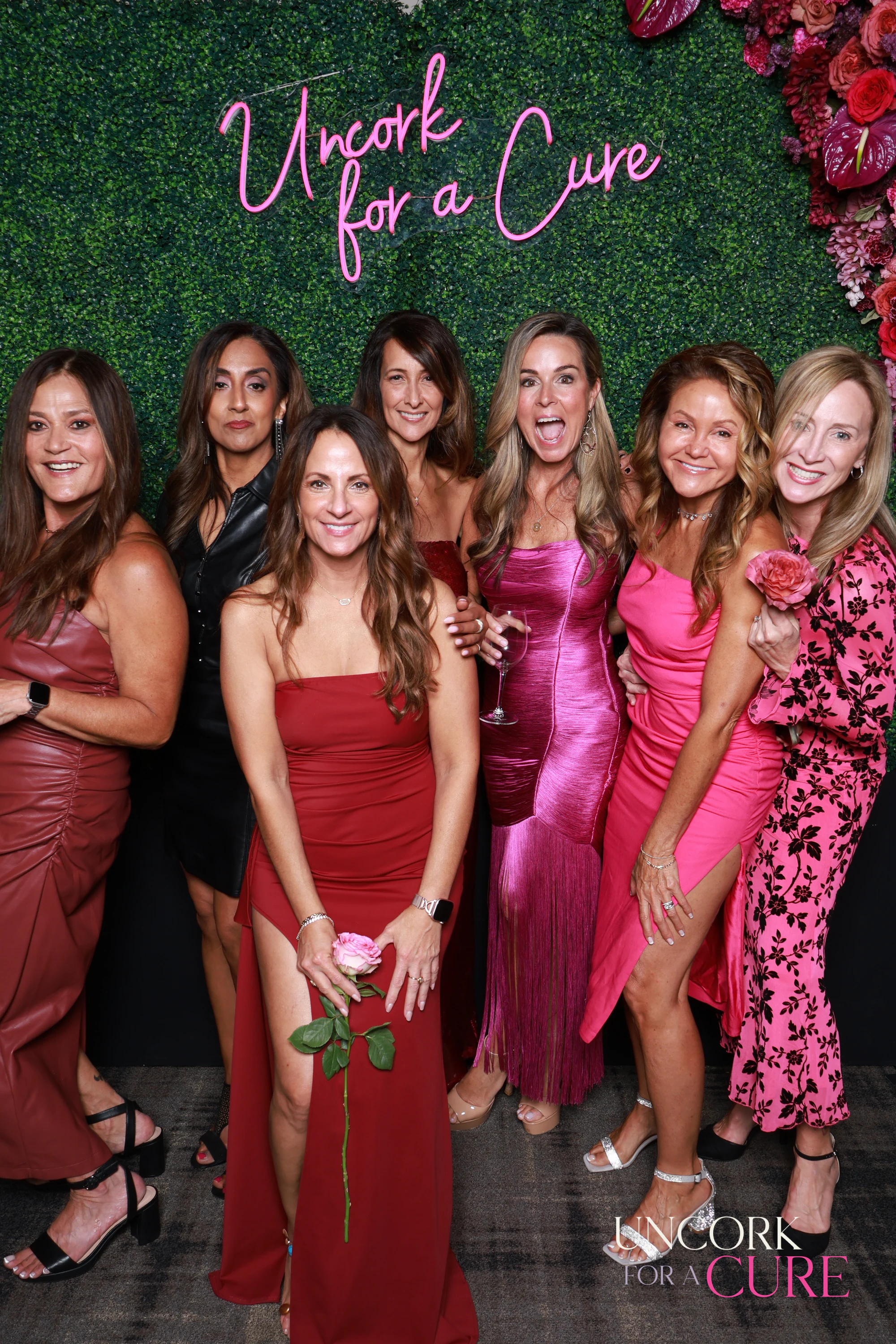 The seven women, one stepping forward in the middle at Uncork for a Cure 2026