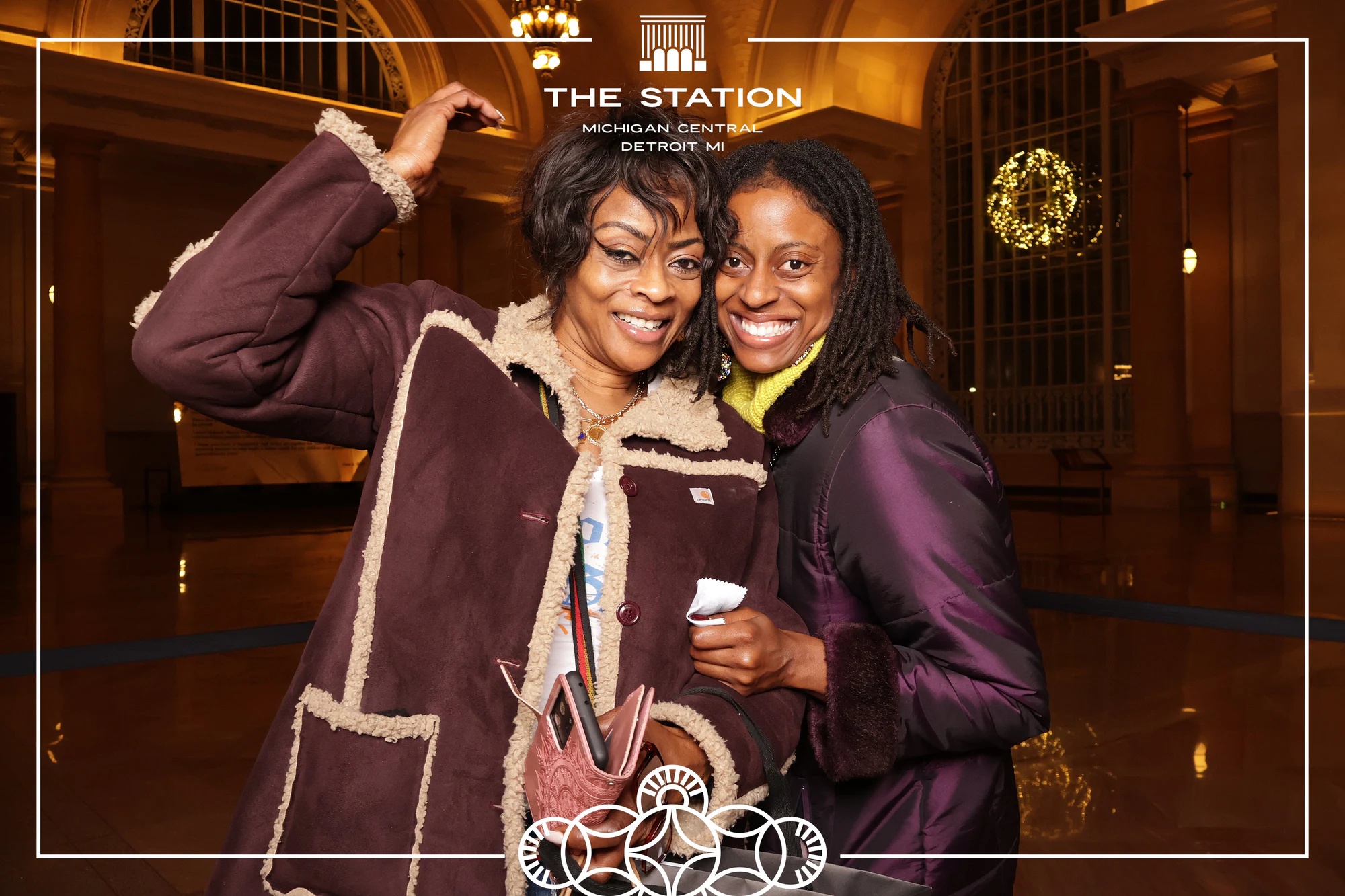 Two friends in a fur coat, mid-laugh at Winter at the Station, Michigan Central