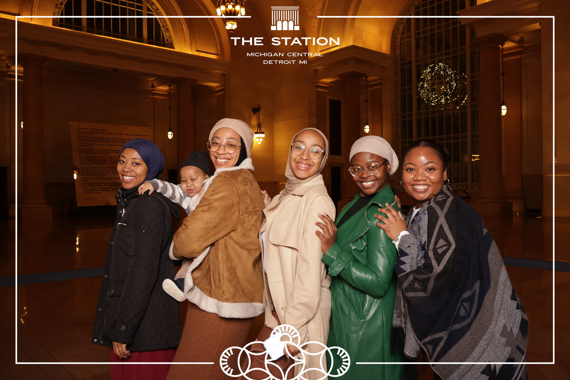Five friends, wide smiles, filling the frame at Winter at the Station, Michigan Central