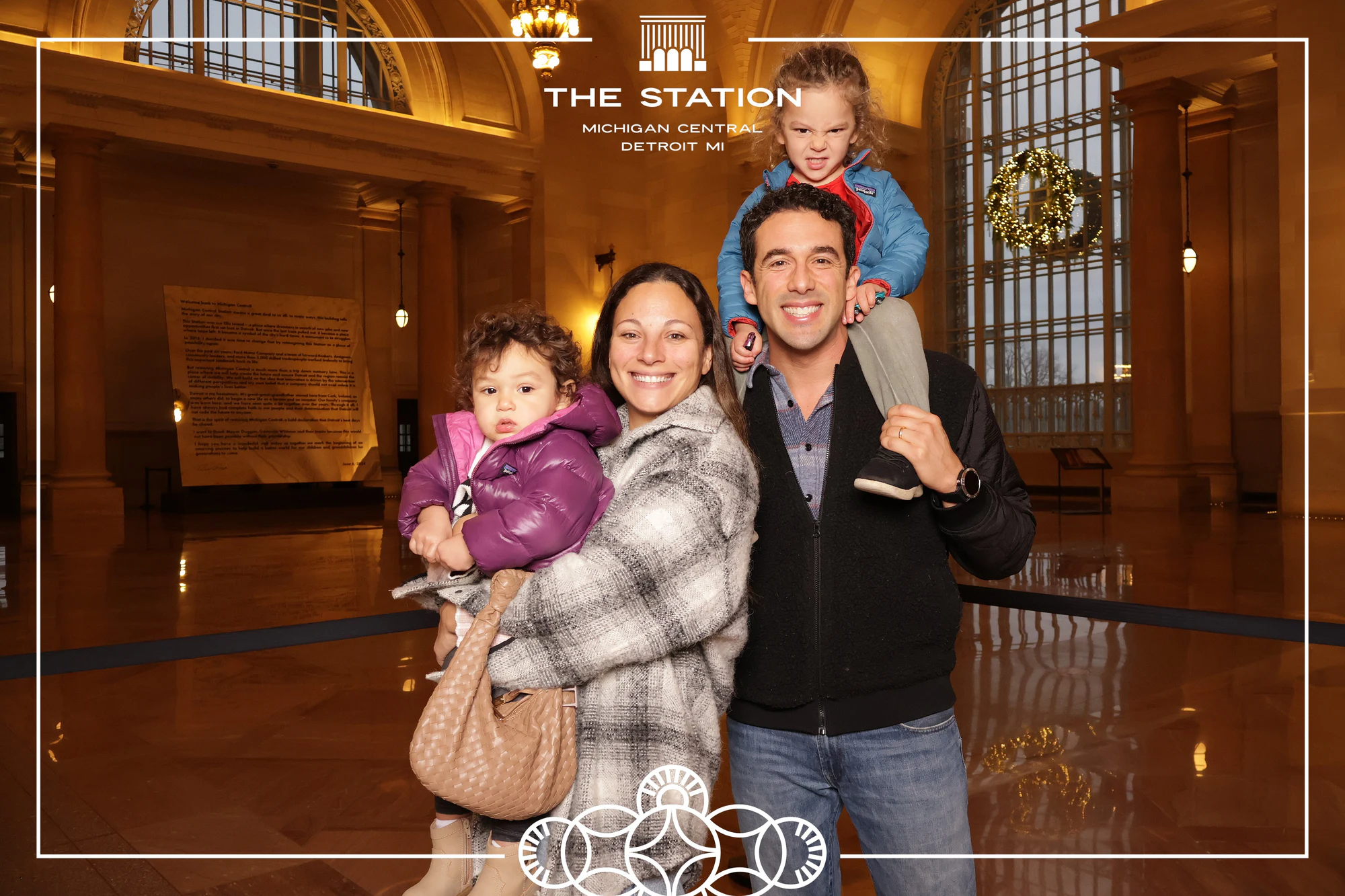 Dad with a kid on his shoulders at Winter at the Station, Michigan Central