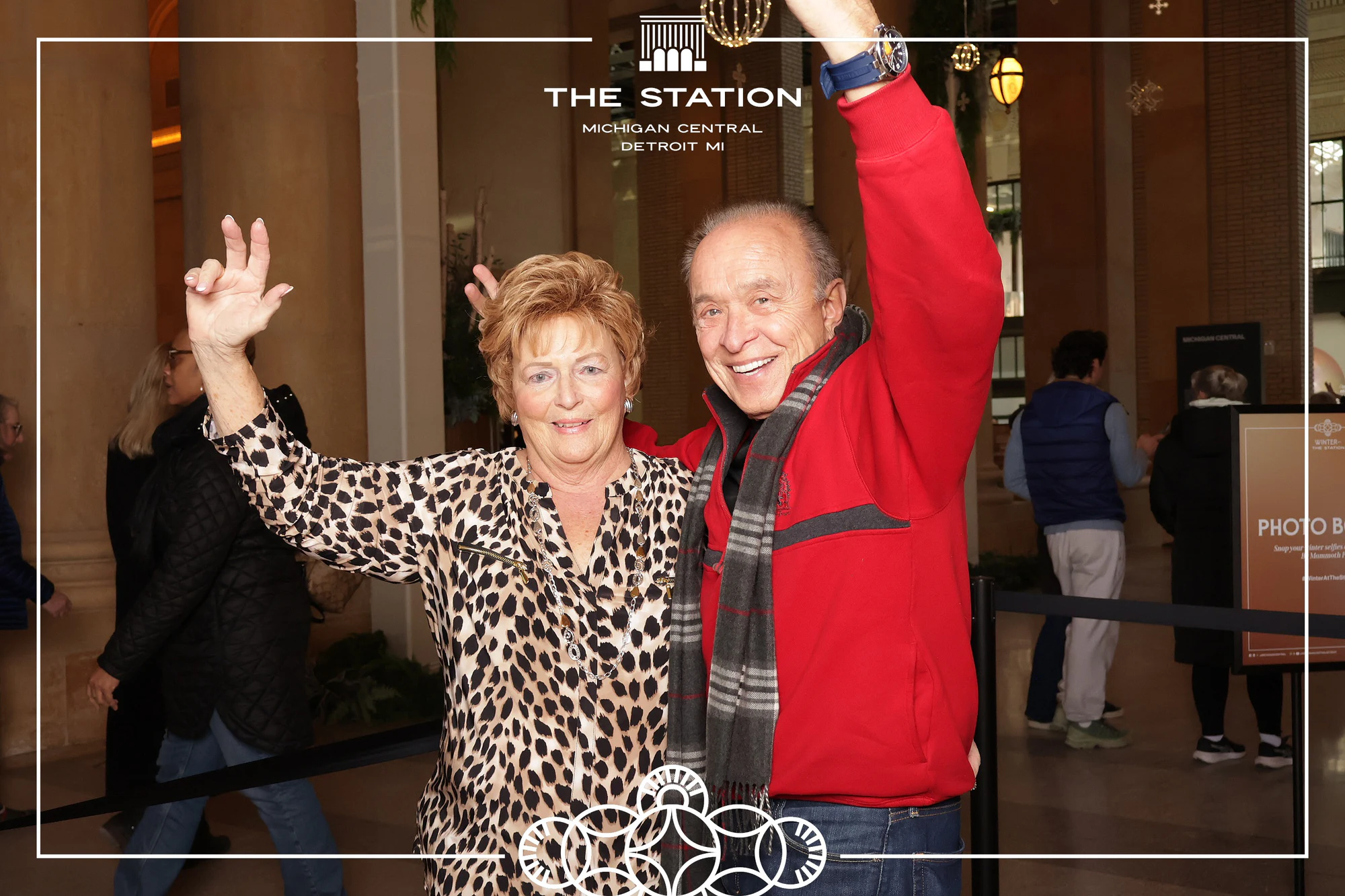 A couple with their arms up in the station lobby at Winter at the Station, Michigan Central