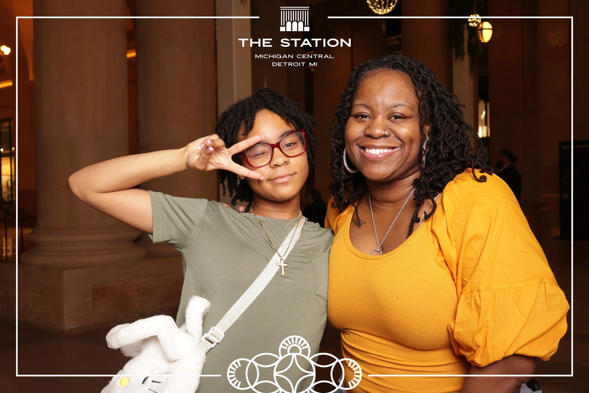 Two friends, one throwing a peace sign at Winter at the Station, Michigan Central