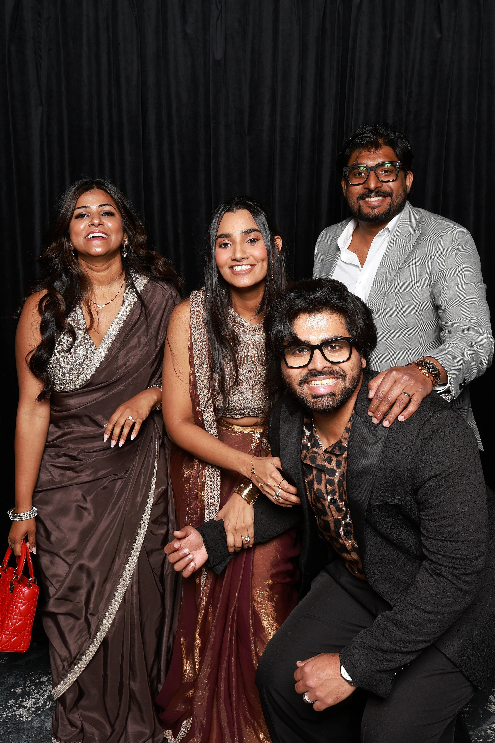 Group of five, one kneeling in front, everyone laughing at once at Yamini + Hari