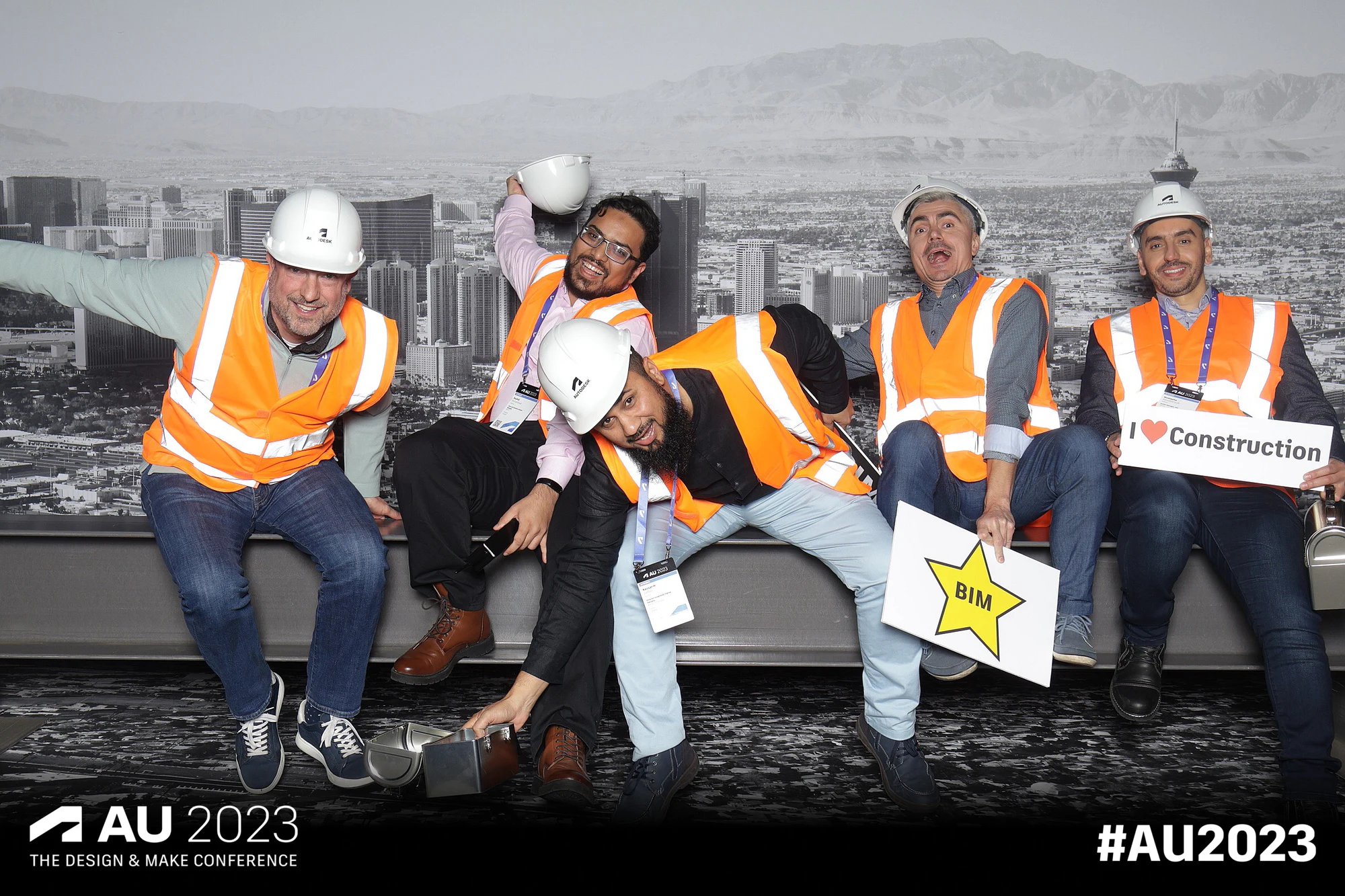 Five with branded signs and props at Autodesk University 2023