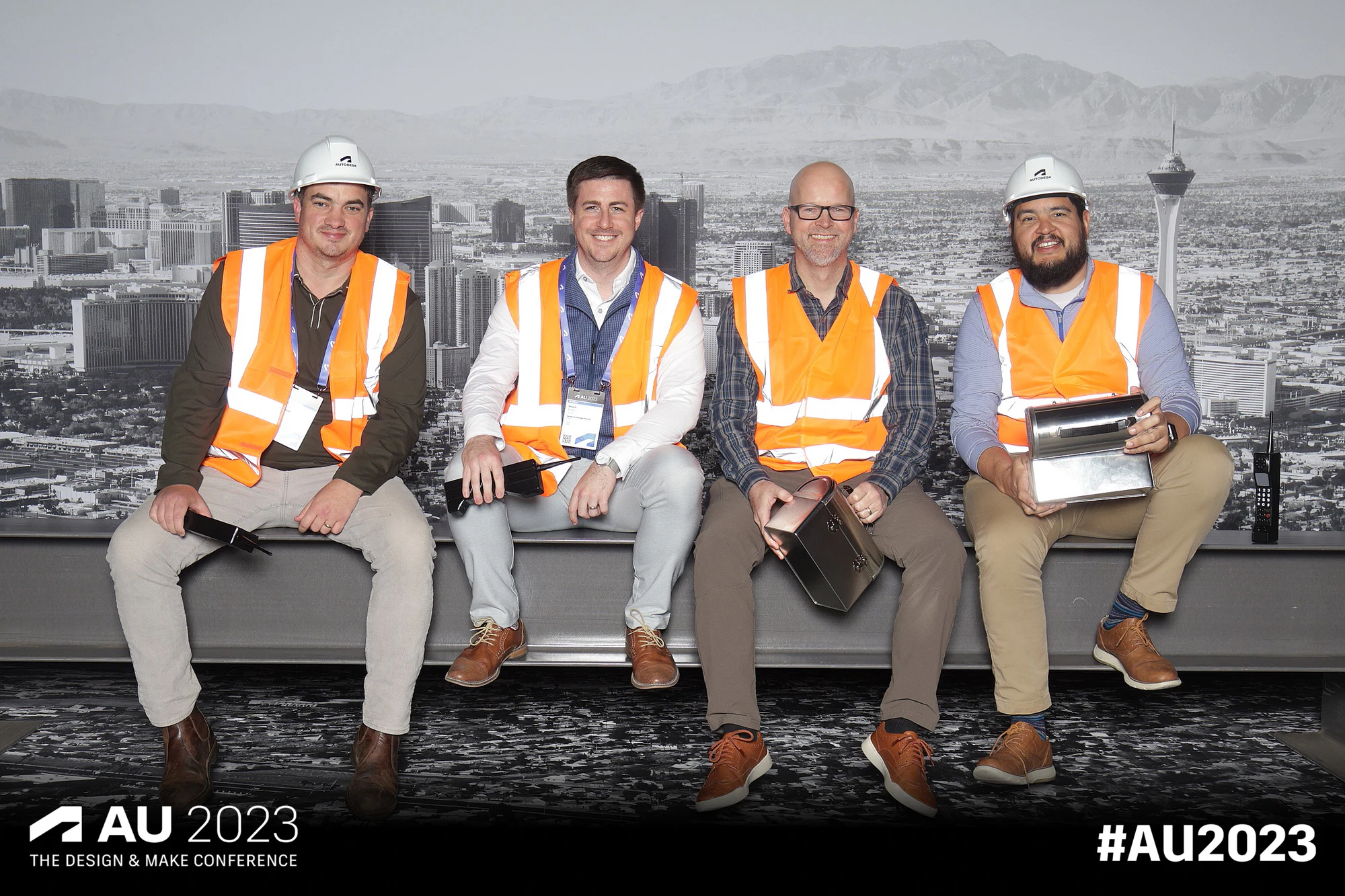 Four seated in a row, badges visible at Autodesk University 2023