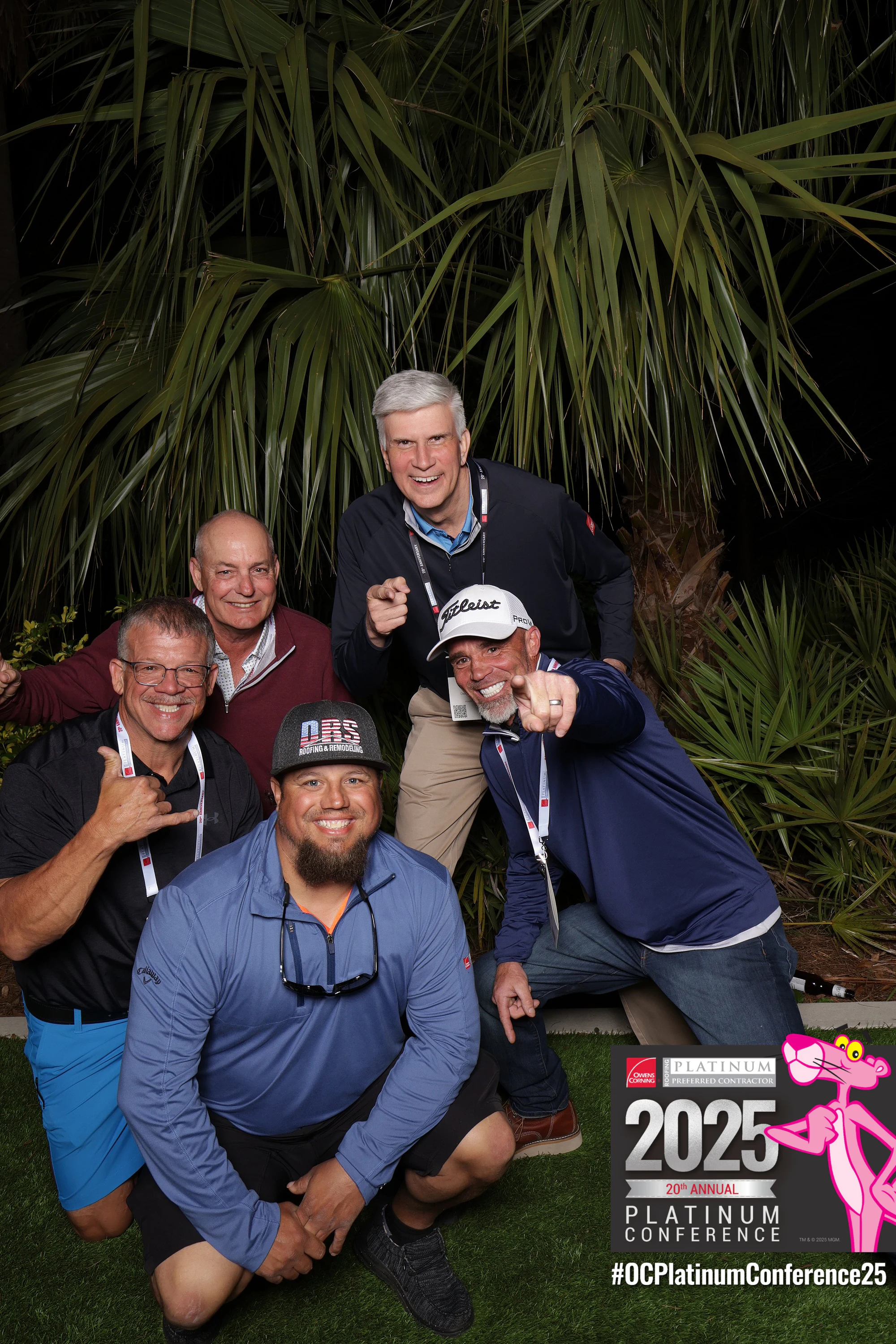 Five leaning in at the garden backdrop, two of them pointing at the camera at Owens Corning Platinum Conference 2025