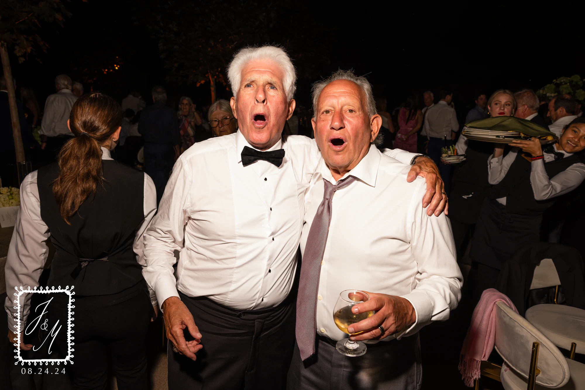 Two older men in white shirts, mouths open mid-laugh, at Jaclyn + Michael at Franklin Hills Country Club